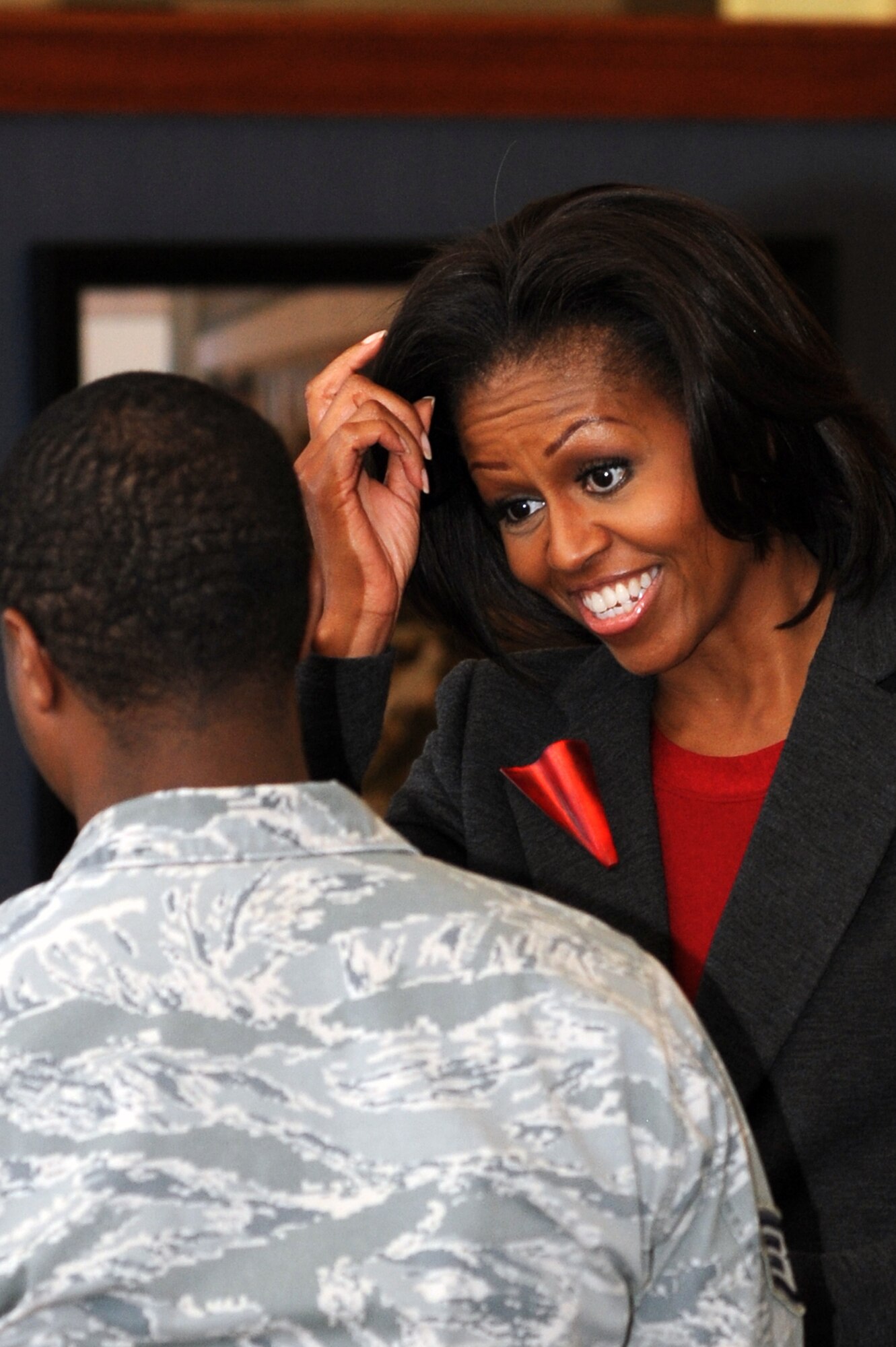 First Lady Michelle Obama speaks to a Team Little Rock Member, Feb. 9, 2012 at Little Rock Air Force Base, Ark. . Little Rock Air Force Base is one of 6 bases to implement the pilot food transformation initiative program, a program designed to provide a wider variety of nutritional meals to service members and their families. (U.S. Air Force Photo by Airman 1st Class Rusty Frank)