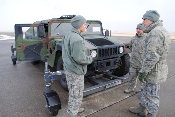 Senior Airman Gini Paccione, 341st Security Forces Squadron training instructor, explains portions of the skid system attached to a Humvee to Col. Robert Mendenhall, 341st Security Forces Group commander, Feb. 2, as Staff Sgt. Eric Tyran, 341st SSPTS training instructor, stands by. (U.S. Air Force photo/Airman 1st Class Cortney Paxton)
