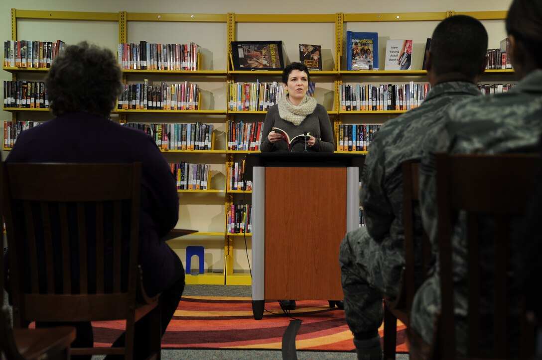 Jehanne Dubrow, author, recites poetry to an audience of Team Andrews service members and spouses at the Joint Base Andrews Library, Feb. 3 during their first Poetry and Pizza event. Dubrow read a compilation of poems from her latest collection “Stateside,” based on dealing with deployment as a military spouse. (U.S. Air Force photo/Senior Airman Bahja J. Jones) 