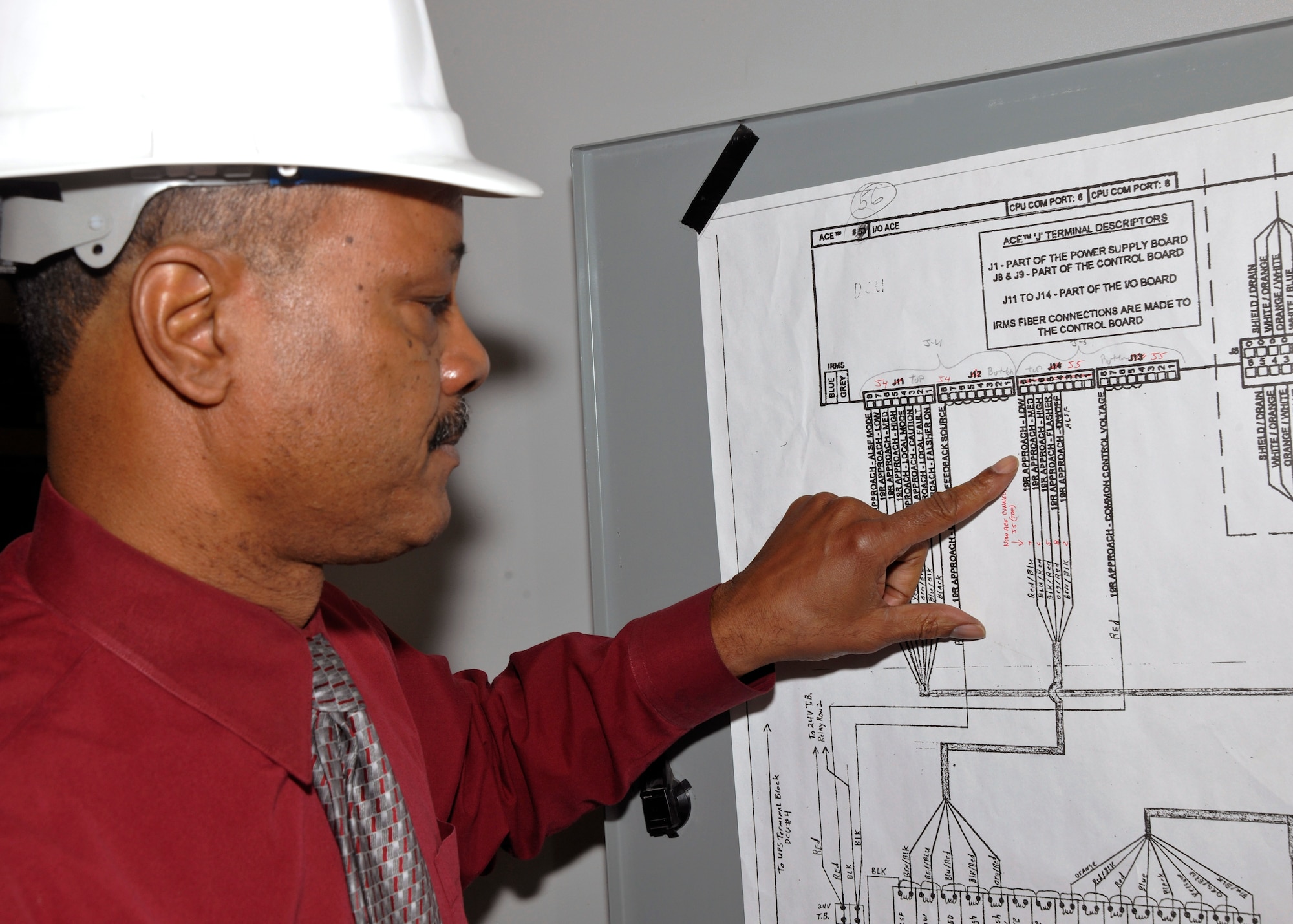 Michael Butts, 11 CES electrical engineering technician, reviews a wiring control diagram inside Building 1207 Feb. 8. Diagrams such as this provide engineers with the information concerning the relays that operate lights on the Joint Base Andrews flightline. Recently, Butts was named Engineer of the Year for Modern Day Technology Leaders by US Black Engineer & Information Technology Magazine.  (U.S. Air Force photo/Airman 1st Class Lindsey A. Beadle)
