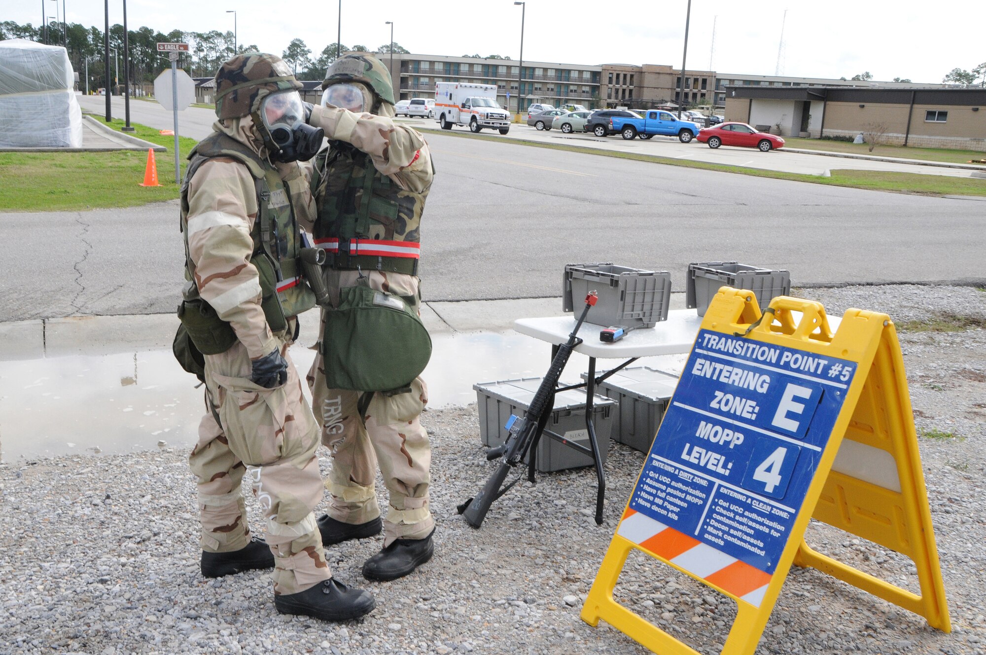 National Guard Tech. Sgt. Charles Delano checks National Guard Tech. Sgt. Julian Aviles' MCU-2 protective mask while transitioning between chemical zones during Operation Crisis Reach at Gulfport Combat Readiness Training Center, MS., Feb. 2, 2012. As part of the simulation, Delano escorted Aviles to the squadron operation center with intelligence information.(National Guard photo by Staff Sgt. Noel Velez Crespo /released).