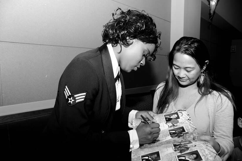 Senior Airman Patrice Brown signs autographs after performing with the Tops in Blue show, Feb 9 at the North Charleston Performing Arts Center, S.C.  Brown has been performing with the Air Force's Premiere showcase, Tops in Blue for the past year.  She auditioned last year  at Joint Base Charleston while assigned to the 628th Logistics Readiness Squadron.  She has performed in more than 100 shows around the world.  (U.S. Air Force photo/ Staff Sgt. Nicole Mickle)  