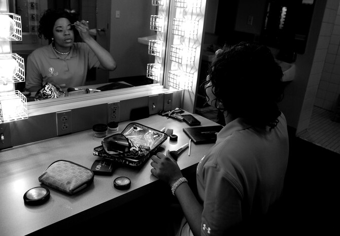 Senior Airman Patrice Brown applies her makeup before performing with the Tops in Blue show, Feb 9 at the North Charleston Performing Arts Center, S.C.  Brown has been performing with the Air Force's Premiere showcase, Tops in Blue for the past year.  She auditioned last year  at Joint Base Charleston while assigned to the 628th Logistics Readiness Squadron.  She has performed in more than 100 shows around the world.  (U.S. Air Force photo/ Staff Sgt. Nicole Mickle)  