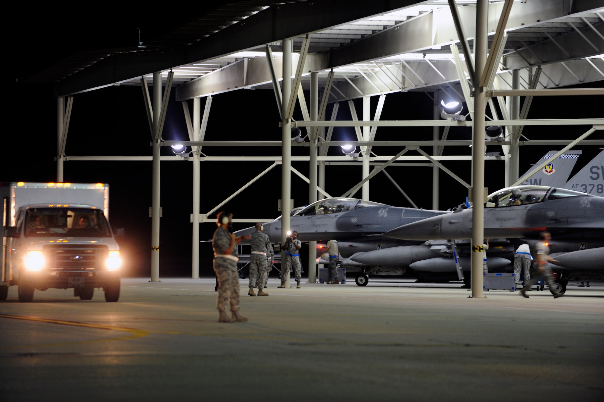 Airmen from the 20th Aircraft Maintenance Squadron scramble on the flightline to support the 77th Fighter Squadron as they depart for Operation Unified Protector. The 20th Fighter Wing received short notice deployment orders and departed in less than 48 hours. (U.S. Air Force photo by Tech. Sgt. Louis Rivers/Released)
