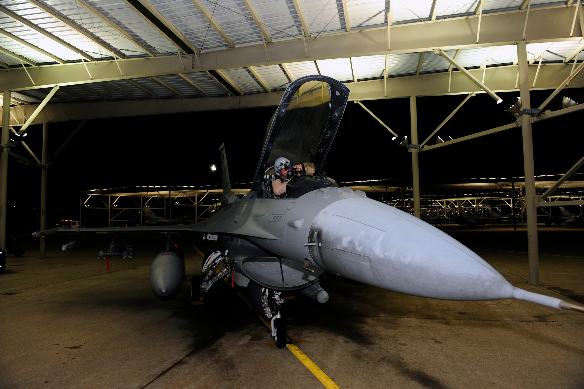 An U.S. Air Force F-16 Fighting Falcon 77th Fighter Squadron pilot makes final adjustments inside of his jet before taking off from Shaw Air Force Base, S.C., to support Operation Unified Protector. The 20th Fighter Wing received short notice deployment orders and departed in less than 48 hours. (U.S. Air Force photo by Tech. Sgt. Louis Rivers /Released)