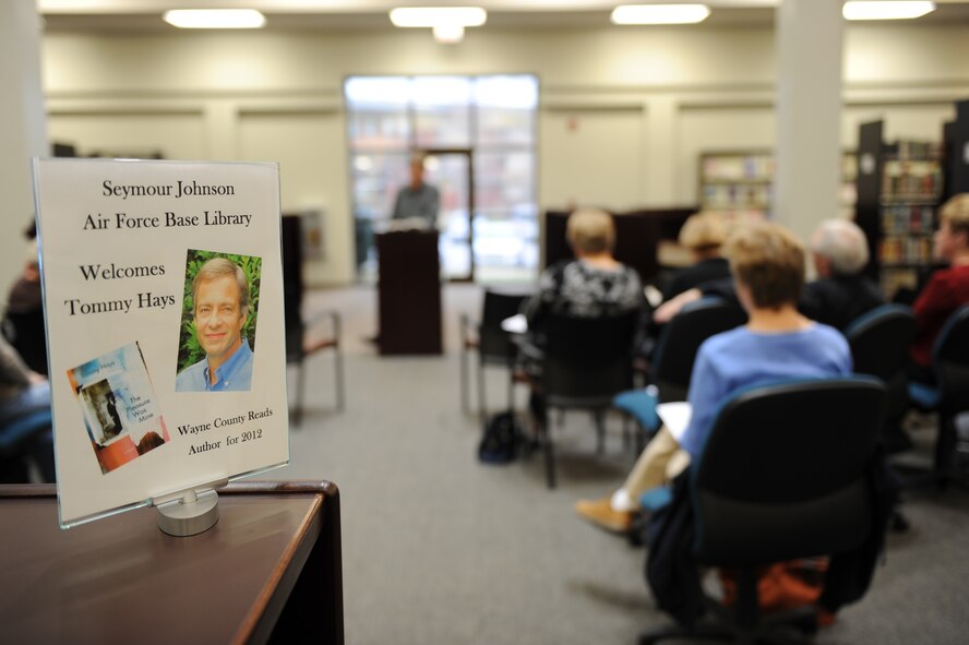 Tommy Hays reads an excerpt from his book “The Pleasure Was Mine” during a “Meet the Author” event at the base library on Seymour Johnson Air Force Base, N.C., Feb. 8, 2012. During the event, Hays discussed the purpose of writing the book and answered questions from the audience. (U.S. Air Force photo/Staff Sgt. Courtney Richardson/Released)