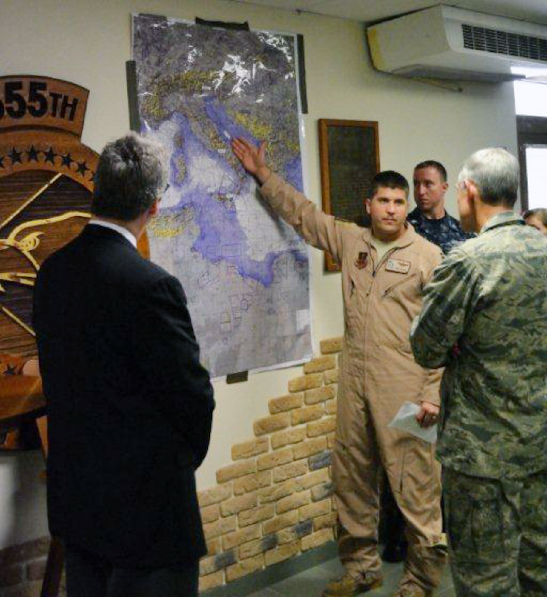 U.S. Air Force Capt. Derrick Franck, 77th Fighter Squadron F-16 Fighting Falcon pilot, briefs U.S. Air Force Chief of Staff Gen. Norton A. Schwartz on the 20th Fighter Wing’s Operation Unified Protector activities at Aviano Air Base, Italy.  The 77th FS deployed to OUP to support NATO forces through the suppression and destruction of enemy air defenses and ensured the safety of NATO assets. (U.S. Air Force courtesy photo/released)