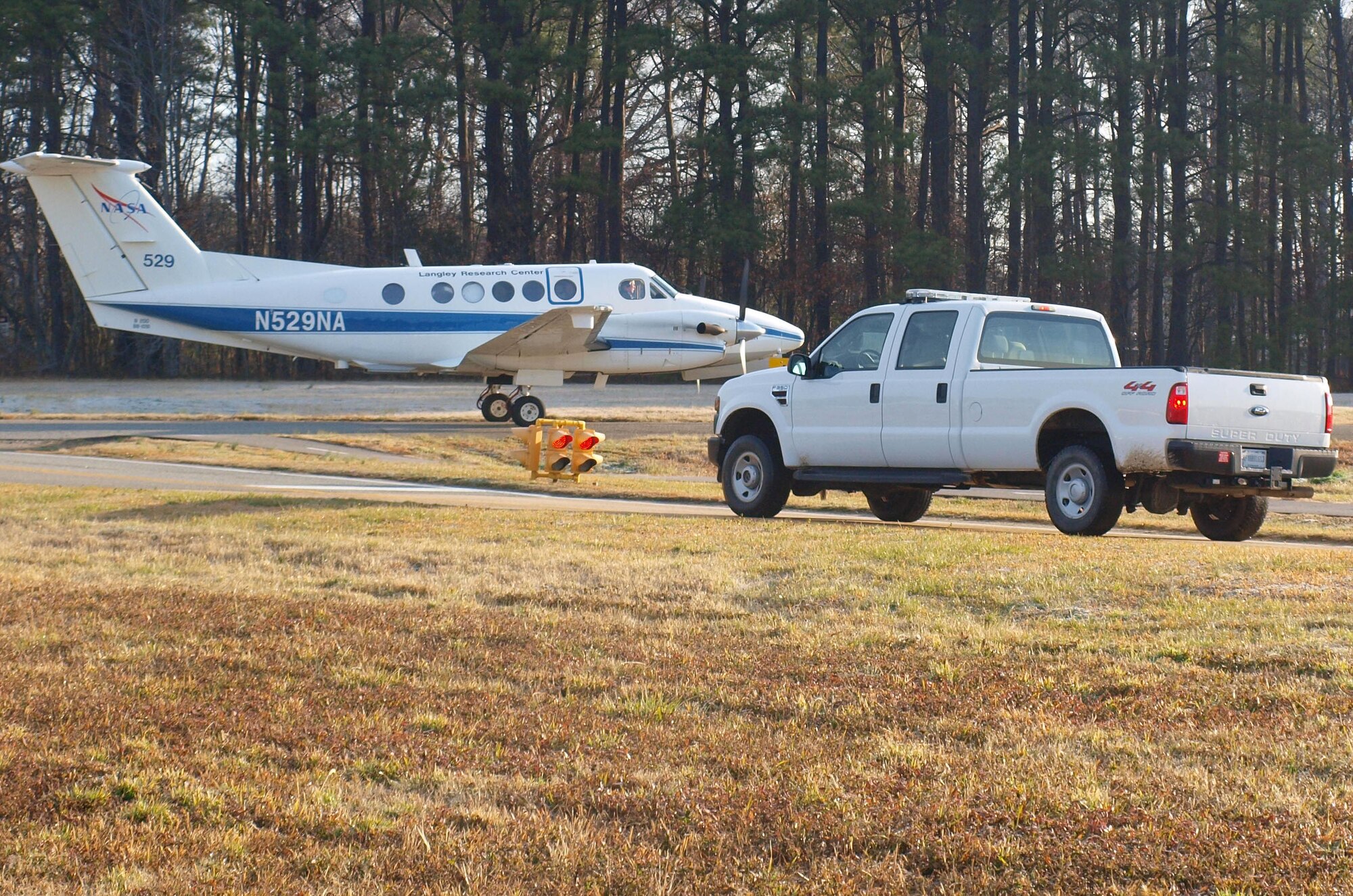 A National Aeronautics and Space Administration aircraft taxis across Lee Road on Langley Air Force Base Feb. 7. Vehicles traveling along Lee Road are failing to properly stop to give way to on-coming aircraft and/or airfield response vehicles. (Courtesy photo/Released)