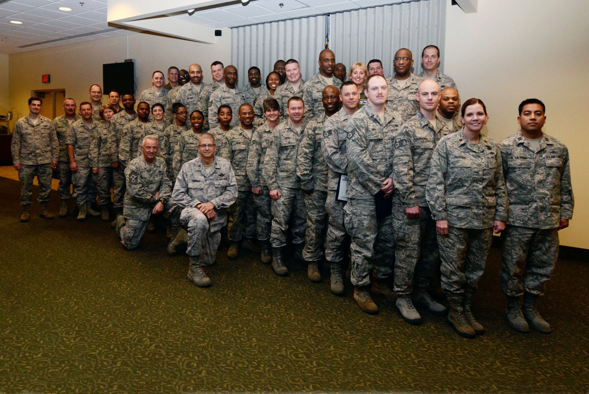 Col. Timothy E. Tarchick, 94th Airlift Wing commander, Chief Master Sgt. Wendell L. Peacock, 94 AW Command, group and unit commanders, first sergeants and supervisors congratulated the wings newest Noncommissioned Officer Leadership and Development course graduates during a ceremony here Feb. 3. The 10 day course combined college level academic management and leadership instruction with military skills applications. Graduates come away with the tools required to meet mission challenges leaders will encounter along their career paths. (U.S. Air Force photo/Don Peek)