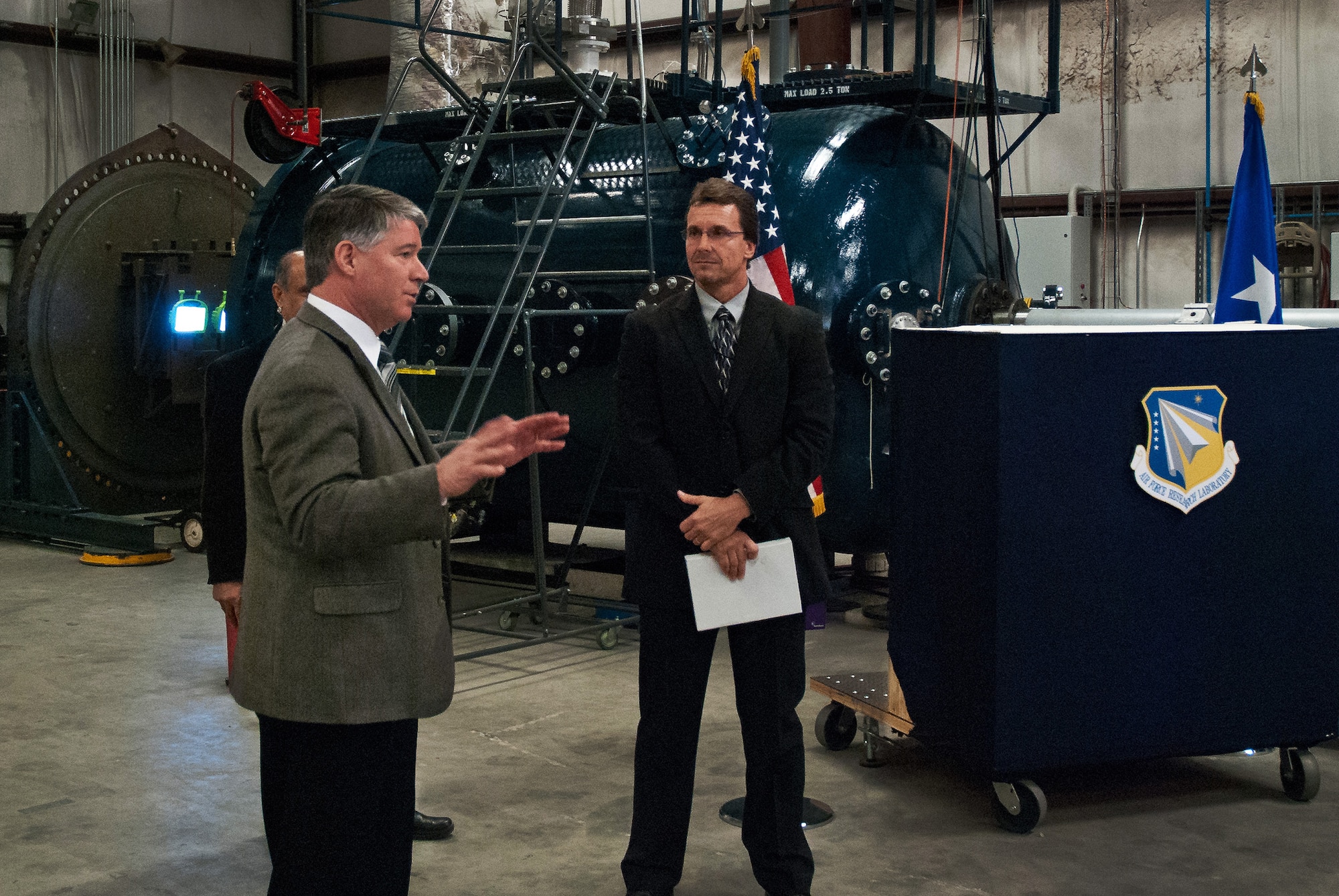 Dr. John Wilcox, Air Force Research Laboratory Munitions Directorate director, and Dr. David Lambert, a senior mechanical engineer at the AFRL Munitions Directorate damage mechanical branch, give an overview of the new High Pressure Particulate Physics Facility at Eglin Air Force Base, Fla., Feb. 6.  The facility was built to enhance the role of science and technology in smart munitions development.  It contains a 60-mm smooth bore gun, complemented with high-resolution, high-precision, time-resolved diagnostics for use with various imaging technologies.  The gun will be able to launch a few kilogram mass at high speed and will address basic questions on material behavior, as it relates to munition weapon systems and weapon effects. (Courtesy photo)  