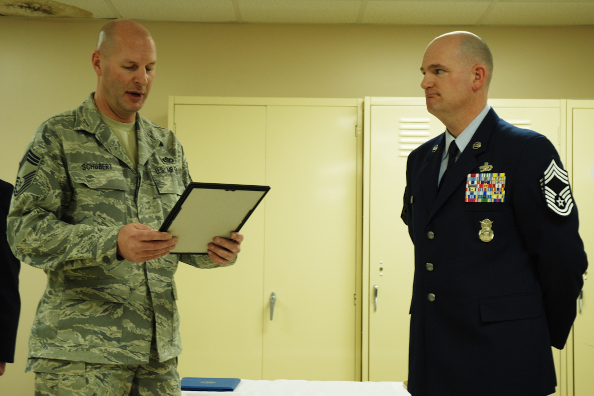 Chief Master Sgt. Mark A. Schubert, 94th Civil Engineering Squadron manager, reads the chief creed to Chief Master Sgt. DeMaine Milbach, 94 SFS manager, during a promotion and pin-on ceremony Feb. 4, at the base firing range. Milbach is succeeding Chief Master Sgt. Wendell Peacock, former 94 SFS manager and current 94th Airlift Wing Command Chief Master Sgt. (U.S. Air Force photo/Senior Airman Spencer Gallien)