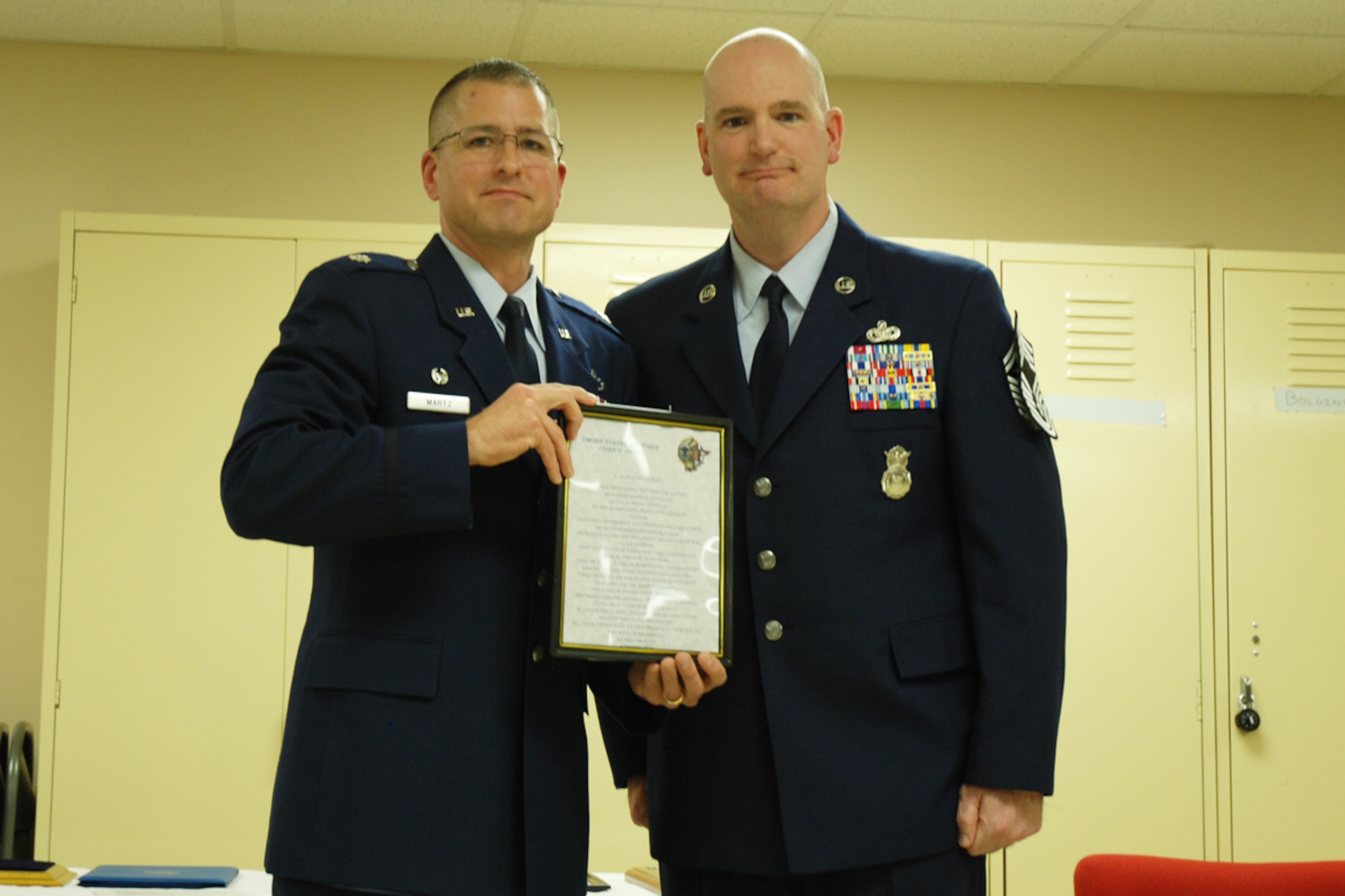 Lt. Col. Timothy Martz, 94th Security Forces Squadron commander, introduces Chief Master Sgt. DeMaine Milbach, 94 SFS manager, during a promotion and pin-on ceremony Feb. 4, at the base firing range. Milbach is succeeding Chief Master Sgt. Wendell Peacock, former 94 SFS manager and current 94th Airlift Wing Command Chief Master Sgt. (U.S. Air Force photo/Senior Airman Spencer Gallien)