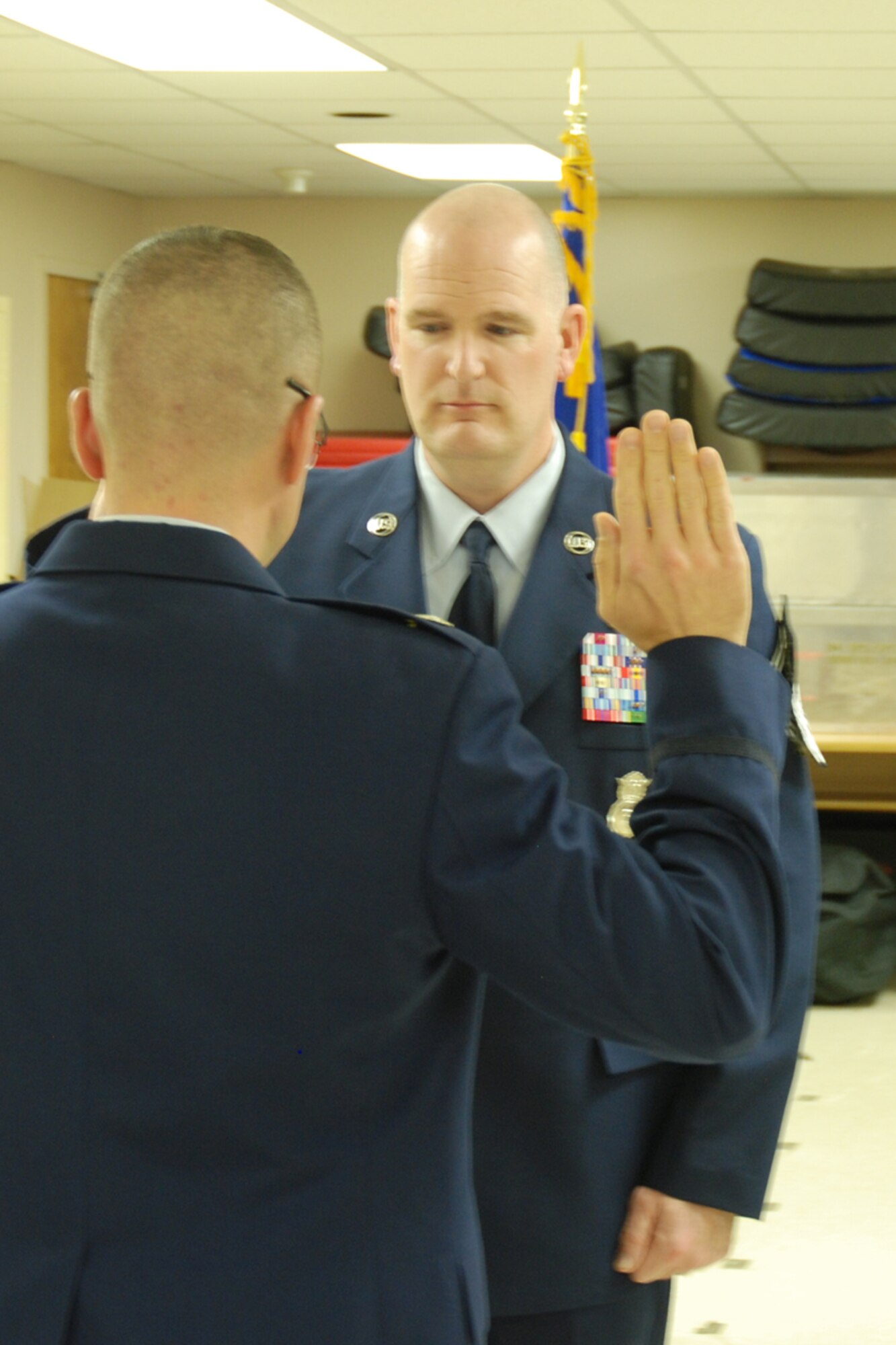 Lt. Col. Timothy Martz, 94th Security Forces Squadron commander, reads the oath of promotion to Chief Master Sgt. DeMaine Milbach, 94 SFS manager, during a promotion and pin-on ceremony Feb. 4, at the base firing range. Milbach is succeeding Chief Master Sgt. Wendell Peacock, former 94 SFS manager and current 94th Airlift Wing Command Chief Master Sgt. (U.S. Air Force photo/Senior Airman Spencer Gallien)