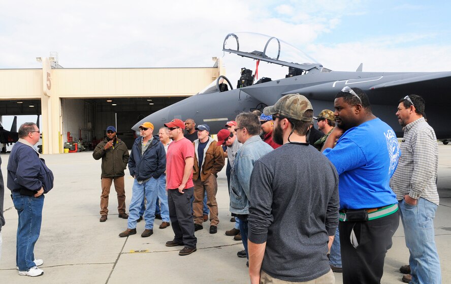 Maintainers and mechanics who worked on the bird strike F-15 gather next to the completed aircraft to listen as Ed Fuller, at left, F-15 planner thanks them for a job well done. U. S. Air Force photo by Sue Sapp
