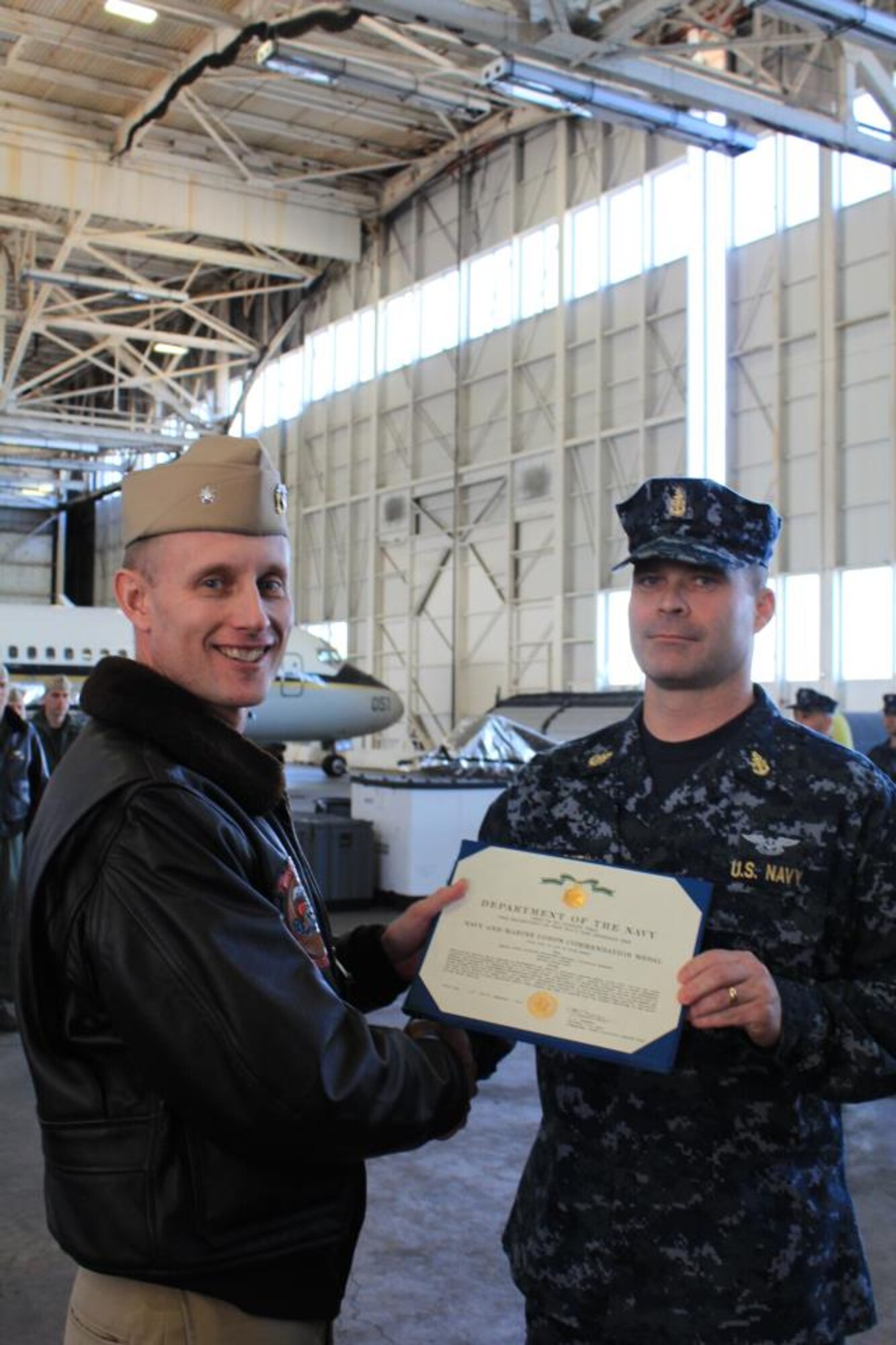 Cmdr. Wayne Gunther, VR-64 commanding officer, awards Chief Petty Officer Charles Starkey, VR-64 aircrewman, with a Naval Commendation Medal Feb. 5 here. The medal is given to Sailors and Marines who distinguish themselves by heroism, meritorious achievement or meritorious service. (U.S. Navy courtesy photo/Released)
