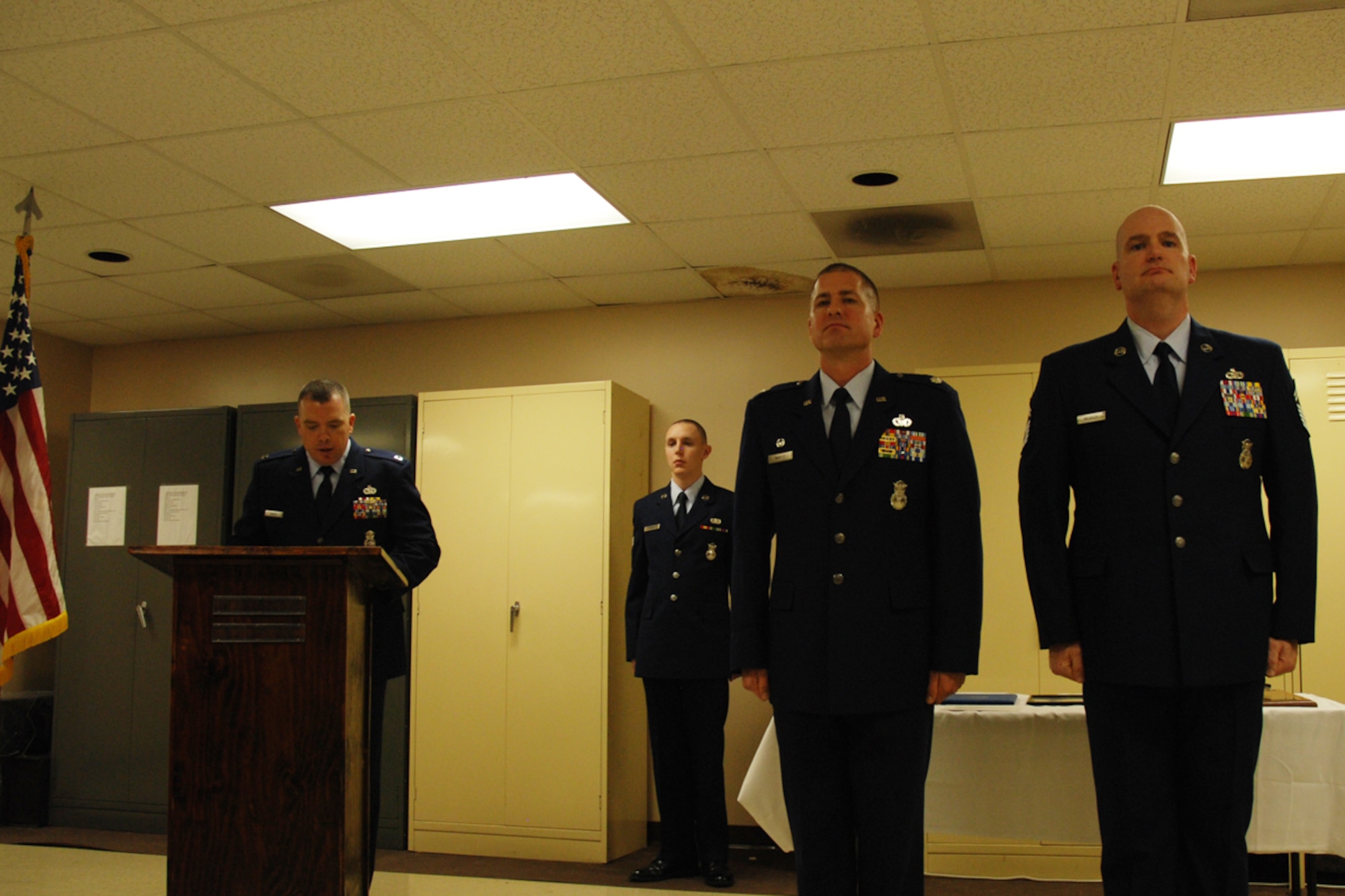 Capt. Robert L. Mayes, 94th Security Forces Squadron operations officer, reads a promotion order for Chief Master Sgt. DeMaine Milbach, 94 SFS manager, during a promotion and pin-on ceremony Feb. 4, at the base firing range. Milbach is succeeding Chief Master Sgt. Wendell Peacock, former 94 SFS manager and current 94th Airlift Wing Command Chief Master Sgt. (U.S. Air Force photo/Senior Airman Spencer Gallien)