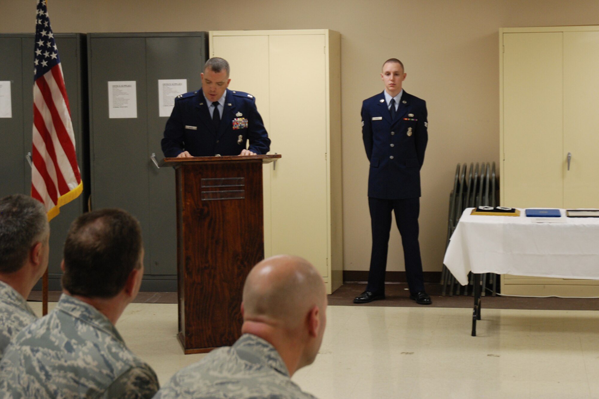 Capt. Robert L. Mayes, 94th Security Forces Squadron operations officer serves as narrator at Chief Master Sgt. DeMaine Milbach, 94 SFS manager's, promotion and pin-on ceremony Feb. 4, at the base firing range. Milbach is succeeding Chief Master Sgt. Wendell Peacock, former 94 SFS manager and current 94th Airlift Wing Command Chief Master Sgt. (U.S. Air Force photo/Senior Airman Spencer Gallien)