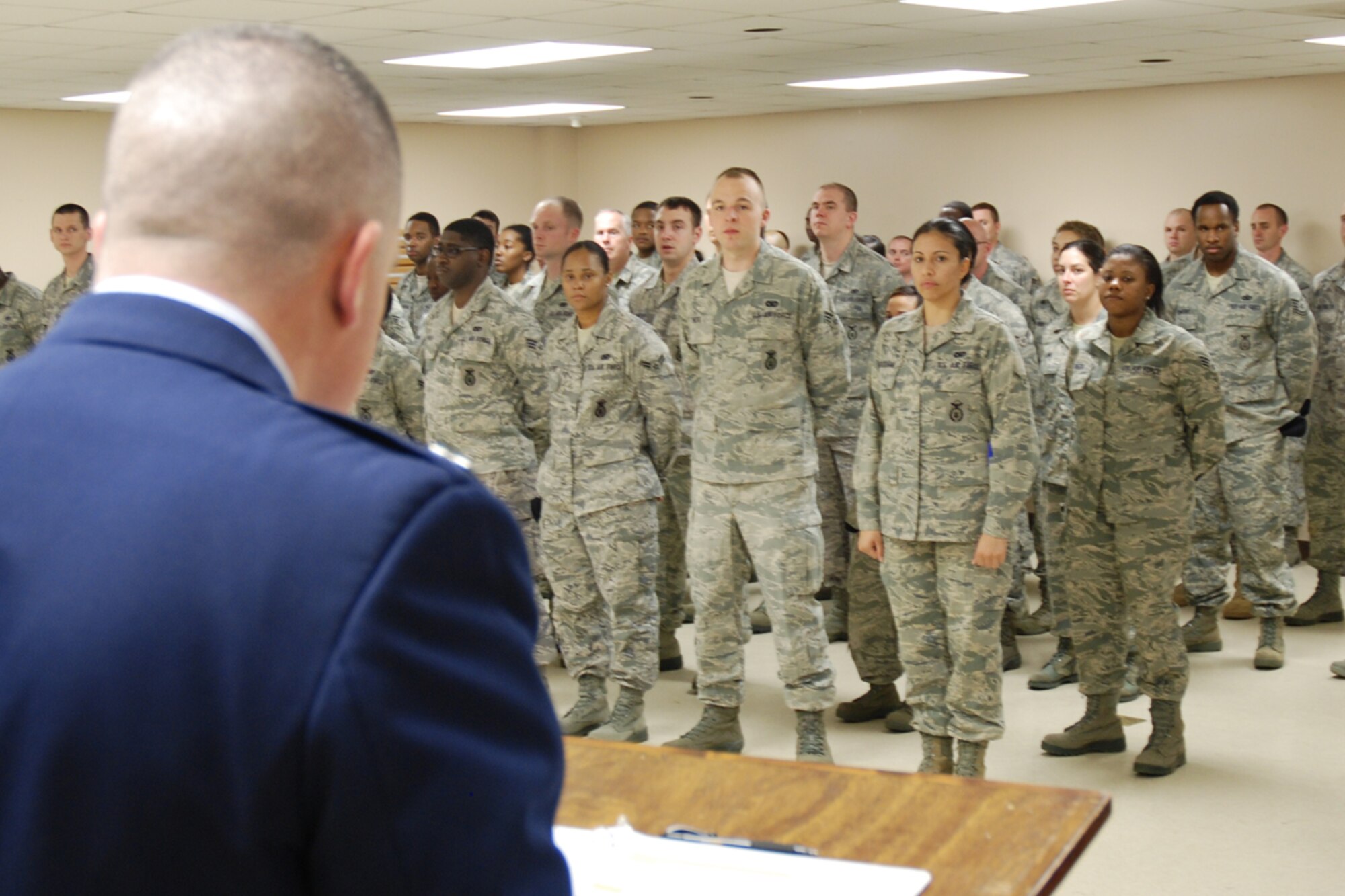 Capt. Robert L. Mayes, 94th Security Forces Squadron operations officer welcomes members of the 94th Airlift Wing to Chief Master Sgt. DeMaine Milbach, 94 SFS manager's, promotion and pin-on ceremony Feb. 4, at the base firing range. Milbach is succeeding Chief Master Sgt. Wendell Peacock, former 94 SFS manager and current 94th Airlift Wing Command Chief Master Sgt. (U.S. Air Force photo/Senior Airman Spencer Gallien)