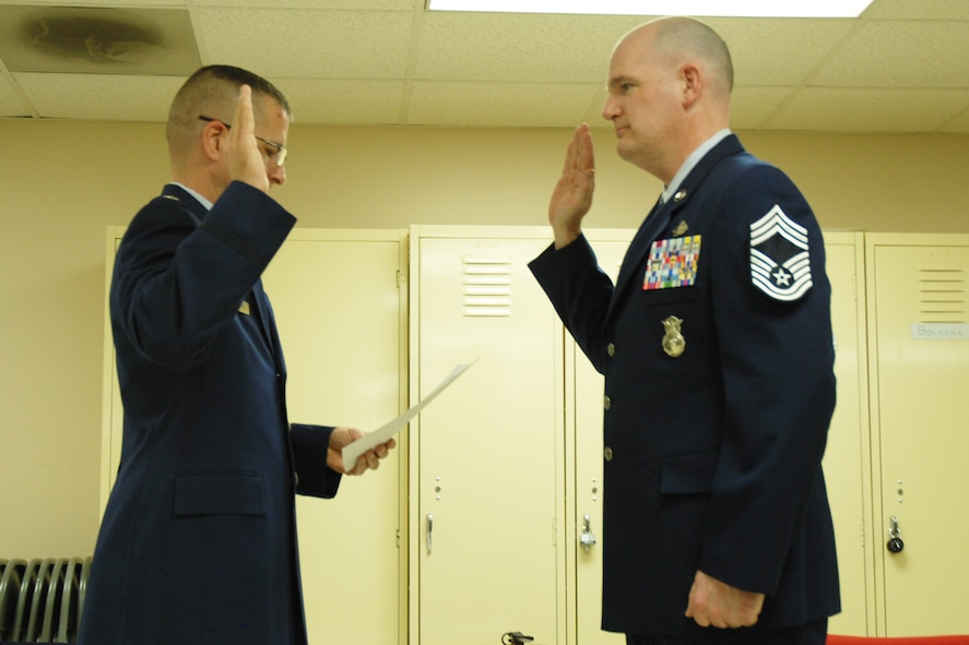 Lt. Col. Timothy Martz, 94th Security Forces Squadron commander, introduces Chief Master Sgt. DeMaine Milbach, 94 SFS manager, during his promotion and pin-on ceremony Feb. 4, at the base firing range. Milbach is succeeding Chief Master Sgt. Wendell Peacock, former 94 SFS manager and current 94th Airlift Wing Command Chief Master Sgt. (U.S. Air Force photo/Senior Airman Spencer Gallien)