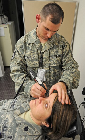 U.S. Air Force Tech. Sgt. Joel Ives performs a pachymeter test on U.S. Air Force Lt. Col. Holly Ellenberger at the 4th Aerospace Medicine Squadron optometry clinic on Seymour Johnson Air Force Base, N.C., Feb. 7, 2012. This test measures the thickness of the cornea which allows surgeons to see the layout of their patients eyes so they can check for defects. Ives, 4th Aerospace Medicine Squadron ophthalmic technician, hails from Argyle, N.Y. Ellenberger, 4th Aerospace Medicine Squadron dental flight commander, hails from Bexley, Ohio. (U.S. Air Force photo/Senior Airman Gino Reyes/Released)


