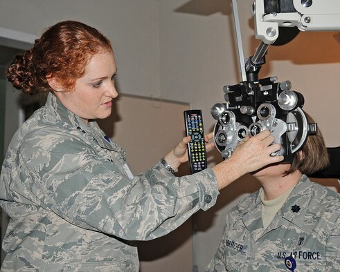 U.S. Air Force Capt. Andrea Rope rotates lenses to determine U.S. Air Force Lt. Col. Holly Ellenberger’s lens prescription at the 4th Aerospace Medicine Squadron optometry clinic on Seymour Johnson Air Force Base, N.C., Feb. 7, 2012. Rope flips different lenses in front of Ellenberger’s eyes until they find the lens with the best clarity. Rope, 4th AMDS optometry flight commander, hails from Bedford, Ind. Ellenberger, 4th AMDS dental flight commander, hails from Bexley, Ohio. (U.S. Air Force photo/Senior Airman Gino Reyes/Released)