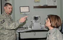 U.S. Air Force Tech. Sgt. Joel Ives checks U.S. Air Force Lt. Col. Holly Ellenberger’s eyes during a refractive eye surgery prescreening at the  4th Aerospace Medicine Squadron optometry clinic on Seymour Johnson Air Force Base, N.C., Feb. 7, 2012. Ives prescreens each patient to identify eye defects and supplies the provider who will perform the surgery with baseline information about the patient. Ives, 4th AMDS ophthalmic technician, hails from Argyle, N.Y. Ellenberger, 4th AMDS dental flight commander, hails from Bexley, Ohio. (U.S. Air Force photo/Senior Airman Gino Reyes/Released)