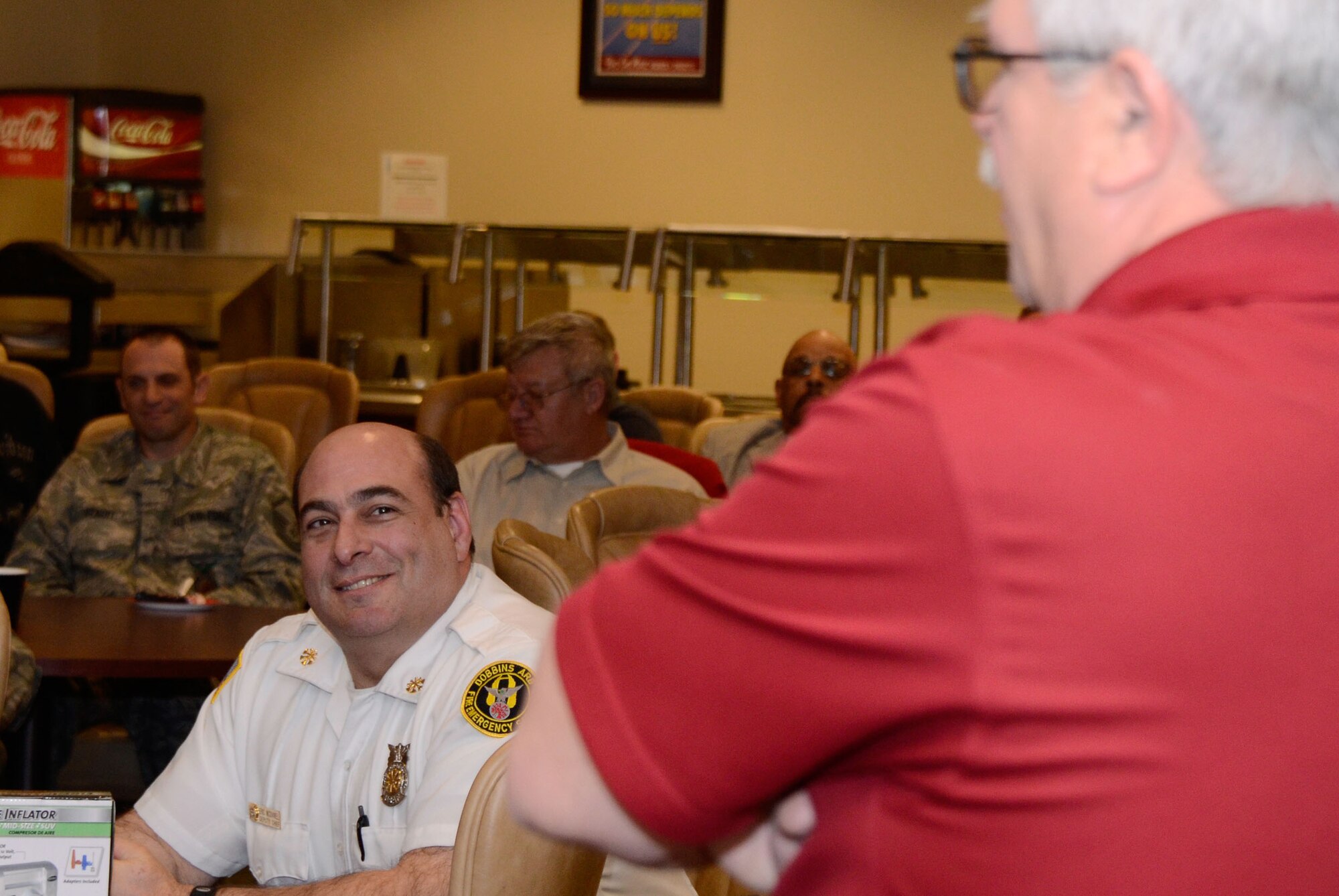 John Hicks, retired fire chief, Dobbins Fire Emergency Services, honors Eric L. McDaniel, Dobbins Fire Emergency Services deputy chief, during his retirement ceremony at the Dobbins Consolidated Club Jan. 17. McDaniel coordinated and executed various patient transport and emergency services during his 33 year career. (U.S. Air Force photo/Don Peek)
