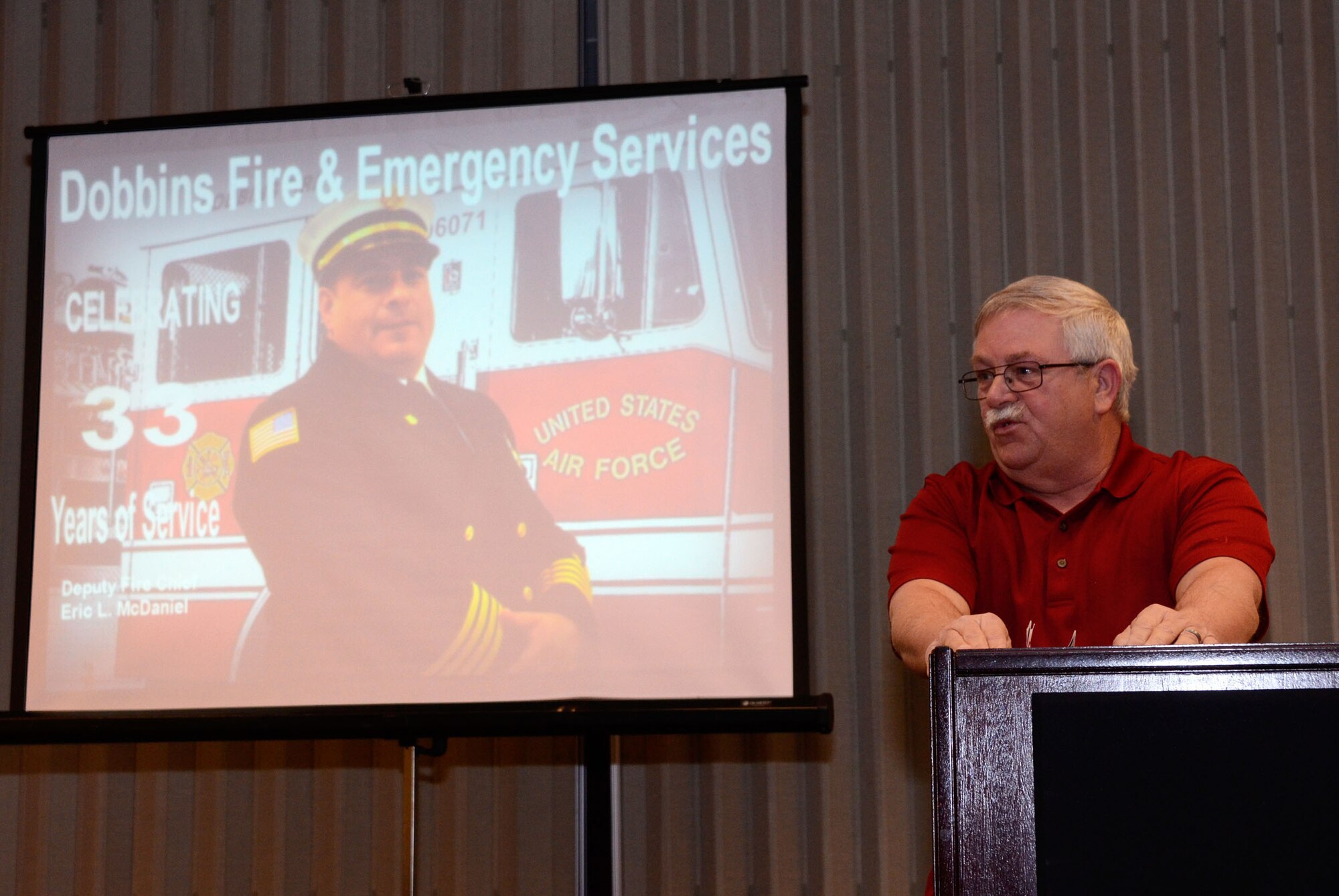 John Hicks, retired fire chief, Dobbins Fire Emergency Services, honors Eric L. McDaniel, Dobbins Fire Emergency Services deputy chief, during his retirement ceremony at the Dobbins Consolidated Club Jan. 17. McDaniel coordinated and executed various patient transport and emergency services during his 33 year career. (U.S. Air Force photo/Don Peek)