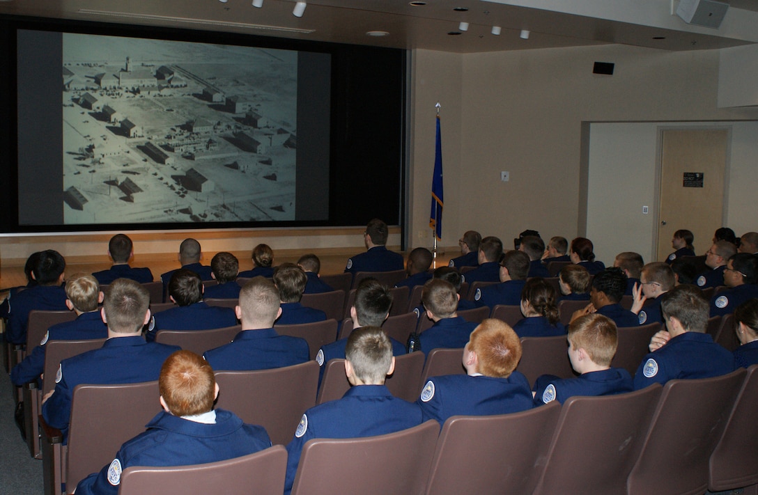 Cadets from the Wylie East High School Junior Reserve Officer Training Corps (JROTC ) watch a video history presentation prior to the start of their tour Feb. 8, 2012. After a video presentation about the base and a welcome from a panel of active-duty Airmen, the 90 cadets and two tour buses departed for tours of both operational units and technical training destinations. (U.S. Air Force photo/Dan Hawkins)