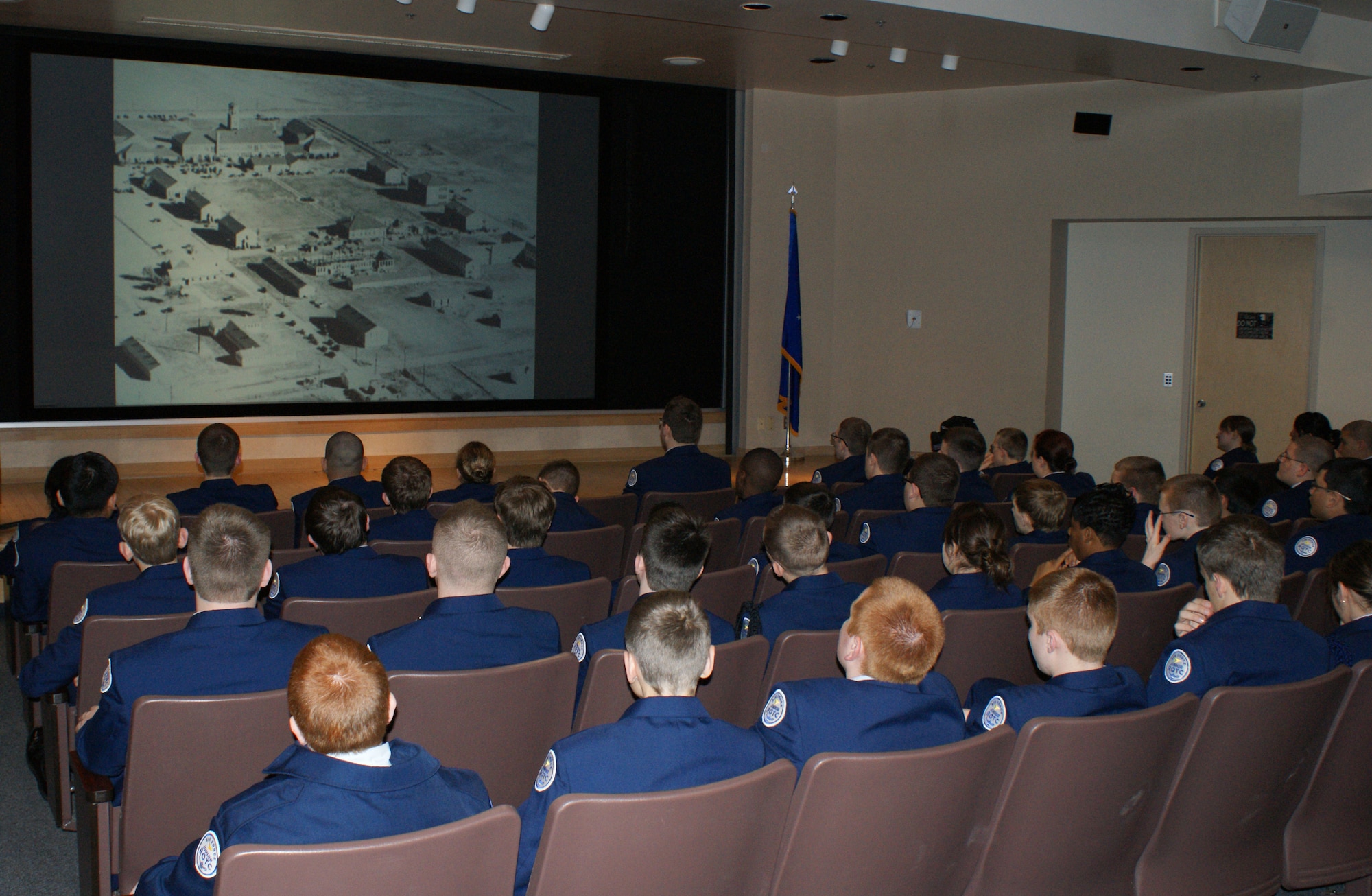 Cadets from the Wylie East High School Junior Reserve Officer Training Corps (JROTC ) watch a video history presentation prior to the start of their tour Feb. 8, 2012. After a video presentation about the base and a welcome from a panel of active-duty Airmen, the 90 cadets and two tour buses departed for tours of both operational units and technical training destinations. (U.S. Air Force photo/Dan Hawkins)