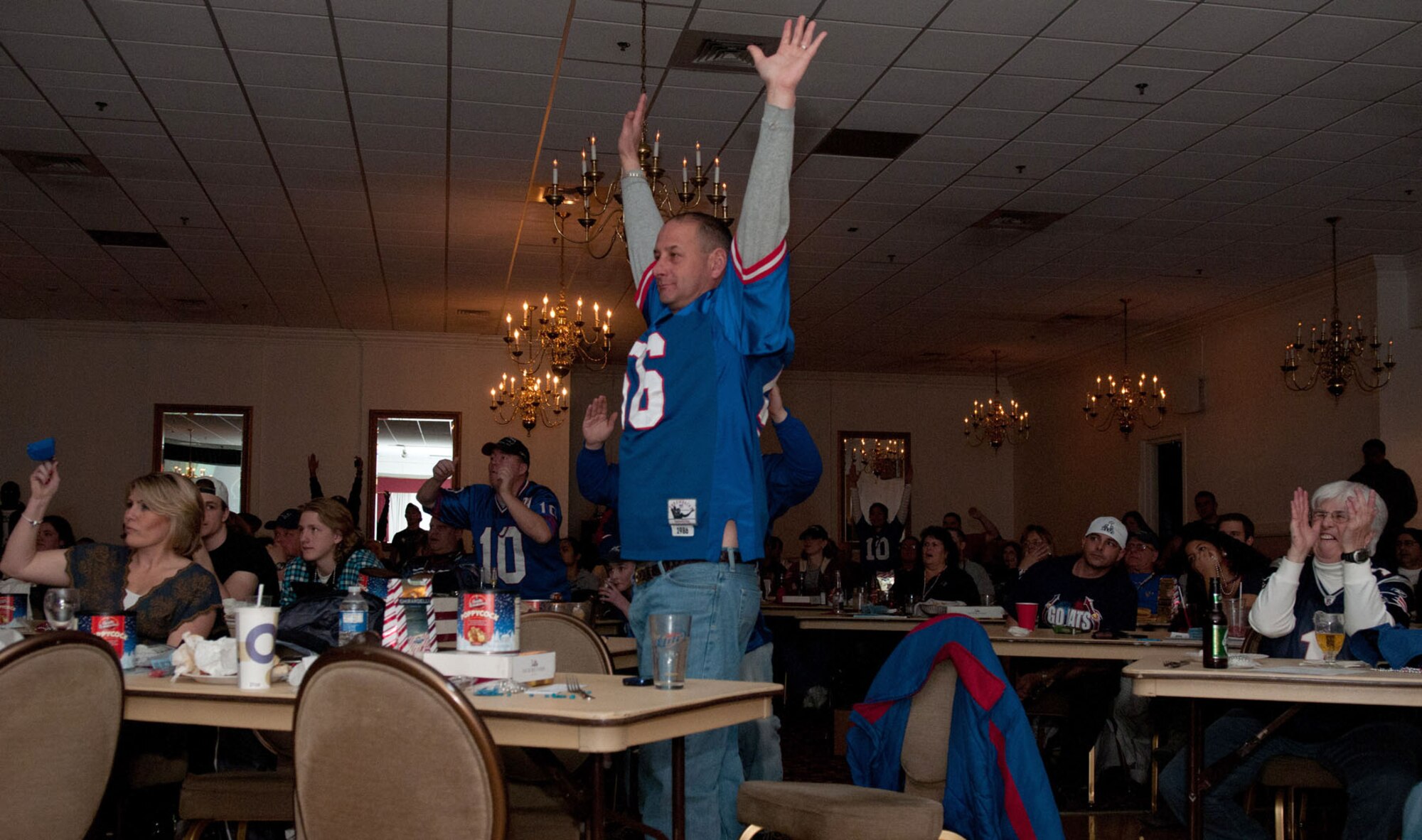 HANSCOM AIR FORCE BASE, Mass. – Chief Master Sgt. Alfred Wilkes (standing) cheers on the New York Giants during the “Big Game” party at the Minuteman Commons Feb. 5. Football fans gathered for games, snacks, giveaways and, of course, to root for their favorite team during the Super Bowl. (U.S. Air Force photo by Rick Berry)