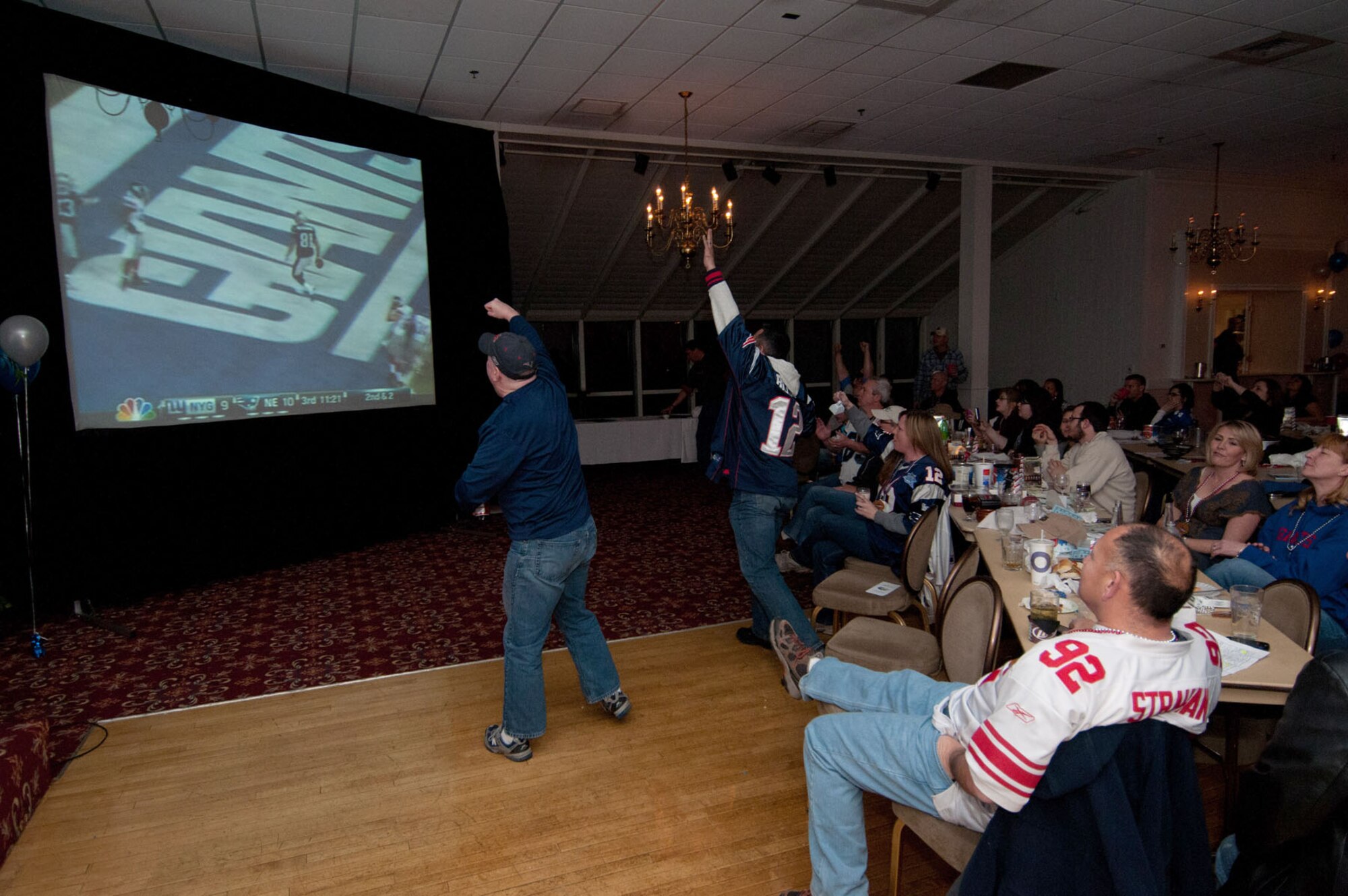 HANSCOM AIR FORCE BASE, Mass. – Fans celebrate after a New England Patriots touchdown during the “Big Game” party at the Minuteman Commons Feb. 5. Football fans gathered for games, snacks, giveaways and, of course, to cheer on their favorite team during the Super Bowl. (U.S. Air Force photo by Rick Berry)