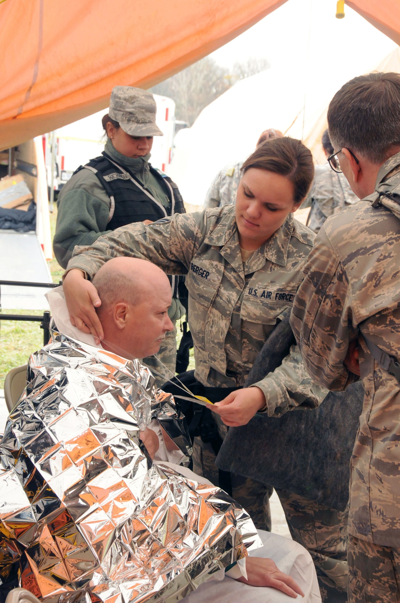Senior Airman Jessica Berger of the 111th Medical Group checks a new patient into the medical treatment area. Several hundred area civilians participated in the exercise serving as injured victims, hysterical bystanders, contaminated personel and rabble rousers, which added heightened realism to the mock event.  Red Rose, a one week exercise held at Fort Indiantown Gap, Pa. Oct. 23-30, 2011, brought together over 570 Army and Air Guard members from all reaches of the state of Pennsylvania.