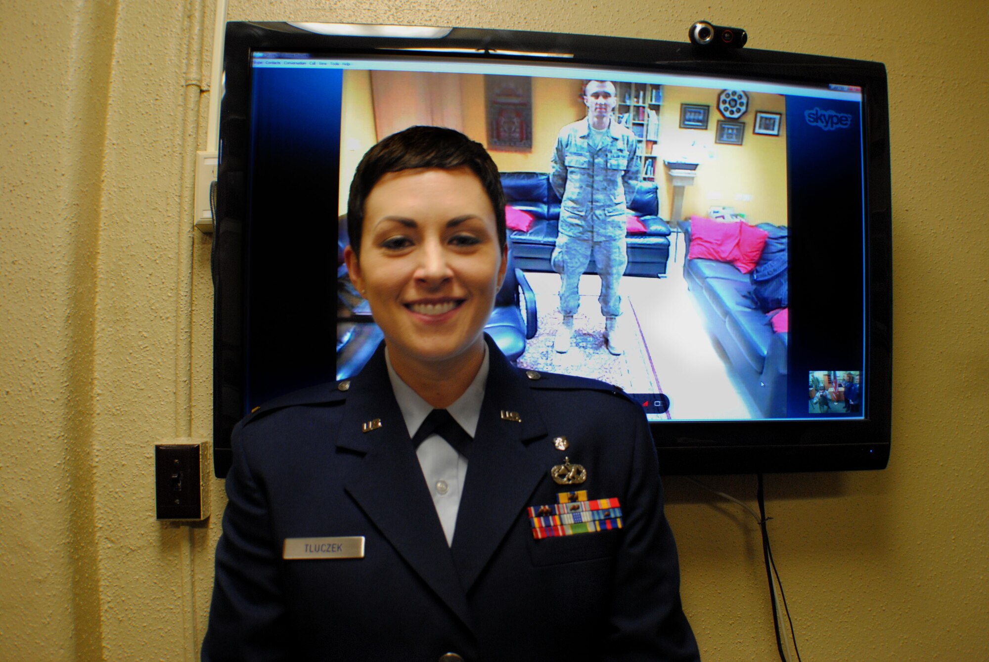 Moments after being commissioned as a second lieutenant in the United States Air Force Nurse Corps, former Staff Sgt. Donna Tluczek stands proudly with her husband, Tech. Sgt. Pawel Tluczek, who witnessed his wife’s commissioning ceremony via a live Internet broadcast, Feb.2, 2012, at the Air Force ROTC Detachment 610 headquarters inside the University of North Dakota Armory. The Tlucezks are a military couple from Grand Forks Air Force Base, N.D. (U.S. Air Force photo/Senior Airman Luis Loza Gutierrez) 