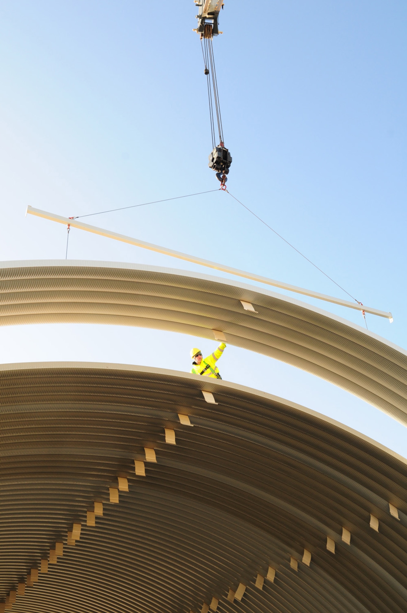RAF MILDENHALL, England -- Tech. Sgt. Thomas Riggsbee, 435th Military Construction Flight, 435th Construction and Training Squadron, near Ramstein Air Base, Germany, helps raise a pick into place on a K-Span structure on the south side of base Jan. 27, 2012. The construction team from Germany – consisting of 14 U.S. Air Force active duty members and one German national -- are based at a geographically-separated unit near Ramstein AB, and have been at RAF Mildenhall since Jan. 9, 2012, putting together the steel structure completely from scratch. Four military members from the 100th Civil Engineer Squadron and two from 48th Civil Engineer Squadron have also assisted in the construction and received beneficial training from the 435th MCF. (U.S. Air Force photo/Karen Abeyasekere)