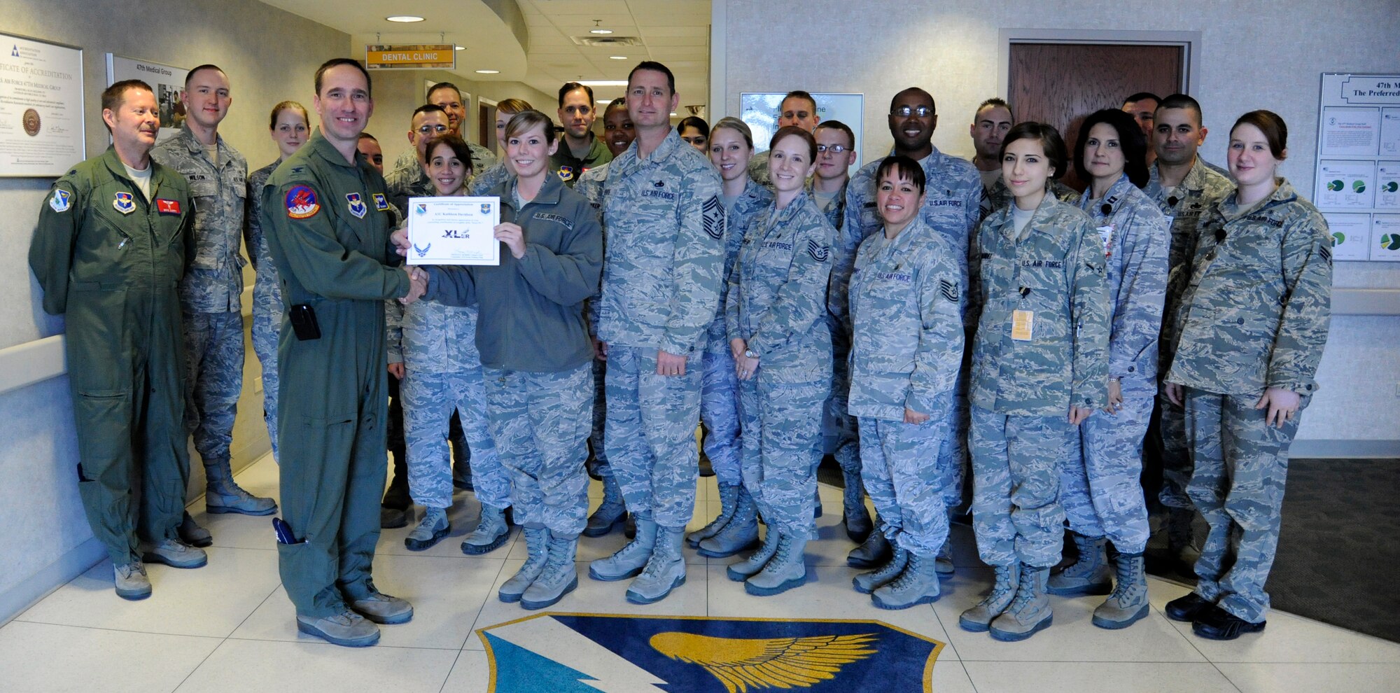 LAUGHLIN AIR FORCE BASE, Texas – Airman 1st Class Kathleen Davidson, 47th Medical Operations Squadron flight medicine technician, poses with Col. Tom Murphy, 47th Flying Training Wing commander, and Chief Master Sgt. Ray DeVite, 47th FTW command chief, after being presented the XLer of the week award here Jan. 18. The XLer is a weekly award chosen by wing leadership and given to those who consistently make outstanding contributions to Laughlin and their unit. (U.S. Air Force photo/Airman 1st Class Nathan L. Maysonet)