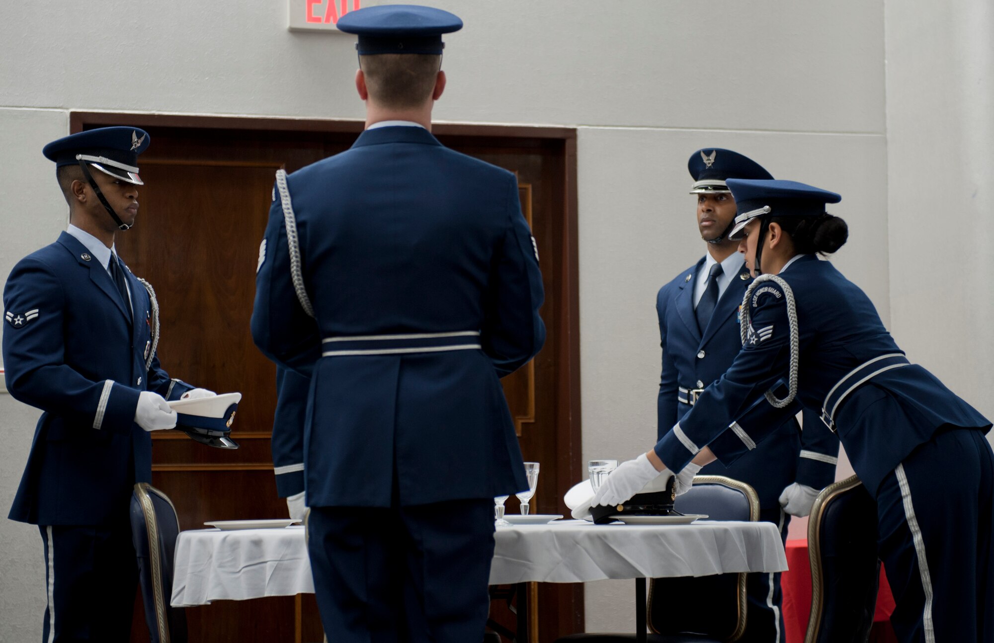 Members of Team Incirlik's honor guard place a hat representing each branch of military on a table reserved for prisoners of war and those missing in action during the 2012 National Prayer Breakfast Feb. 8, 2012, at Incirlik Air Base, Turkey. The annual event is held in conjunction with the National Prayer Breakfast in Washington, D.C. U.S. Air Forces in Europe Command Chaplain Col. G. Scott Henry attended to share words of wisdom as well as to encourage Airmen to be resilient to things that test their faith and to take care of each other. (U.S. Air Force photo by Senior Airman Anthony Sanchelli/Released)