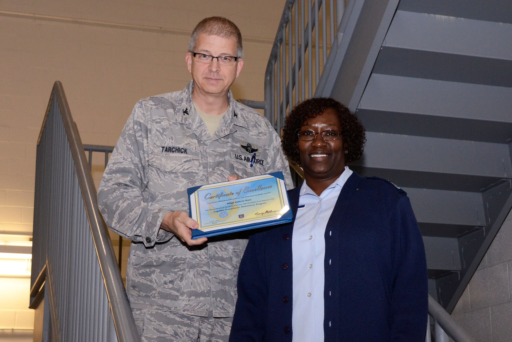 Col. Tim Tarchick, 94th Airlift Wing commander, presents a certificate of excellence and coins to , Master Sgt. Valerie Bass of the 94th Maintenance Operation Flight Feb. 7. Members of the 94th AW satisfactorily completed the Air Force Reserve Command Logistics Compliance Assessment Program (LCAP) inspection with a grade of 80.87. (U.S. Air Force photo/Don Peek)