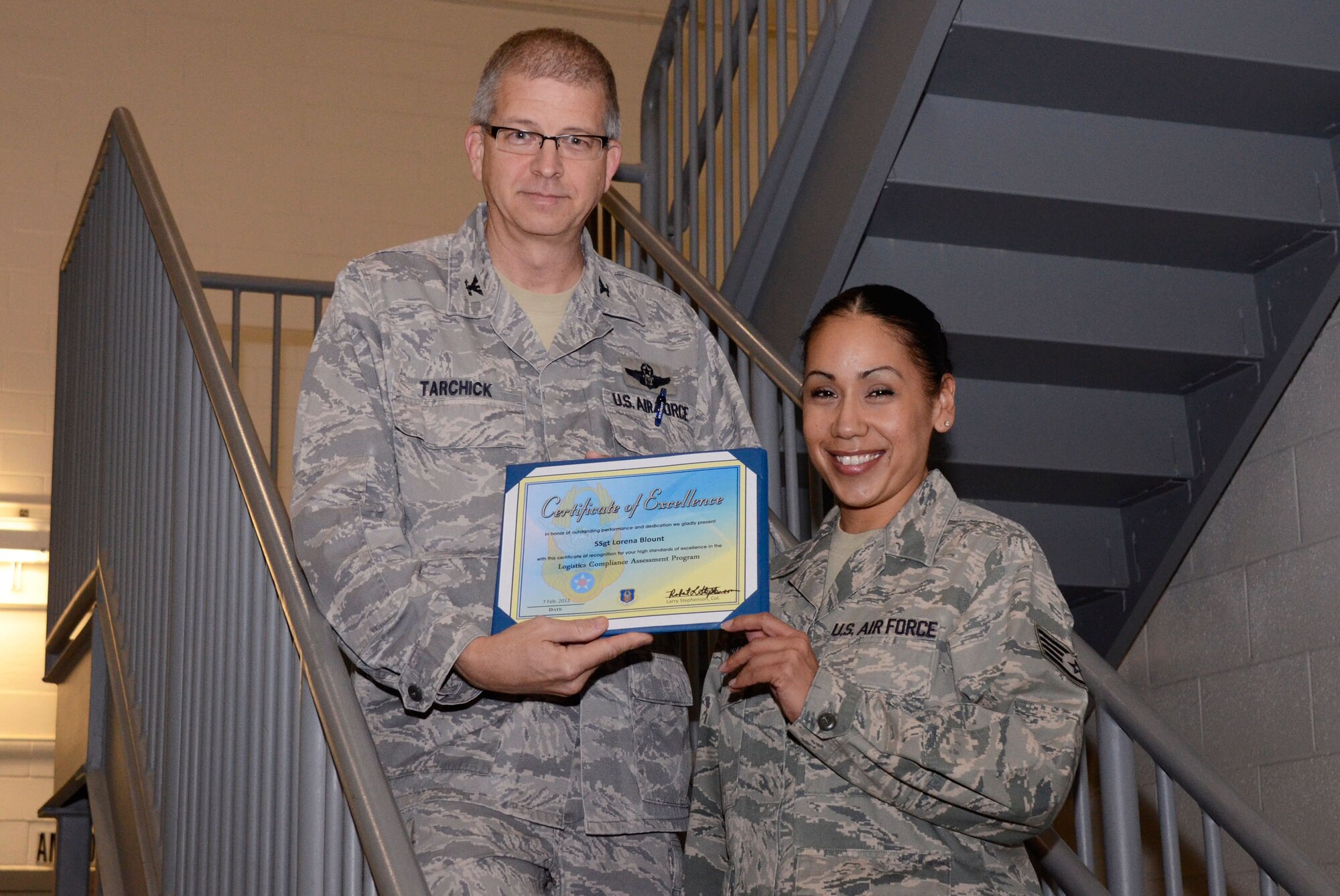 Col. Tim Tarchick, 94th Airlift Wing commander, presents a certificate of excellence and coins to Staff Sgt. Lorena Blount of the 80th Aerial Port Squadron Feb. 7. Members of the 94th AW satisfactorily completed the Air Force Reserve Command Logistics Compliance Assessment Program (LCAP) inspection with a grade of 80.87. (U.S. Air Force photo/Don Peek)