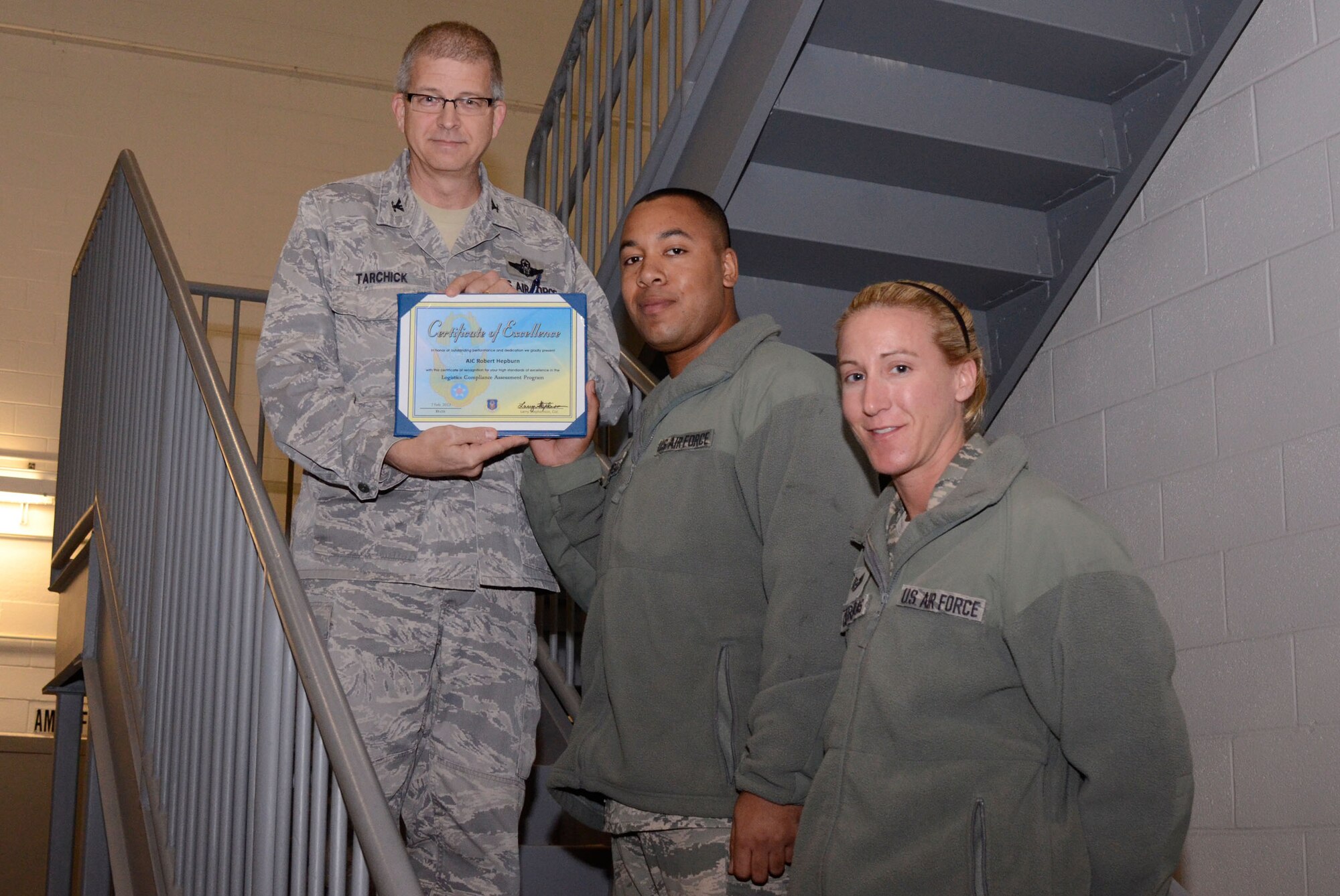 Col. Tim Tarchick, 94th Airlift Wing commander, presents a certificate of excellence and coins to Airman 1st Class Robert Hepburn and his supervisor/trainer, Tech. Sgt. Karie A. Contreras of the 94th Aircraft Maintenance Squadron Feb. 7. Members of the 94th AW satisfactorily completed the Air Force Reserve Command Logistics Compliance Assessment Program (LCAP) inspection with a grade of 80.87. (U.S. Air Force photo/Don Peek)