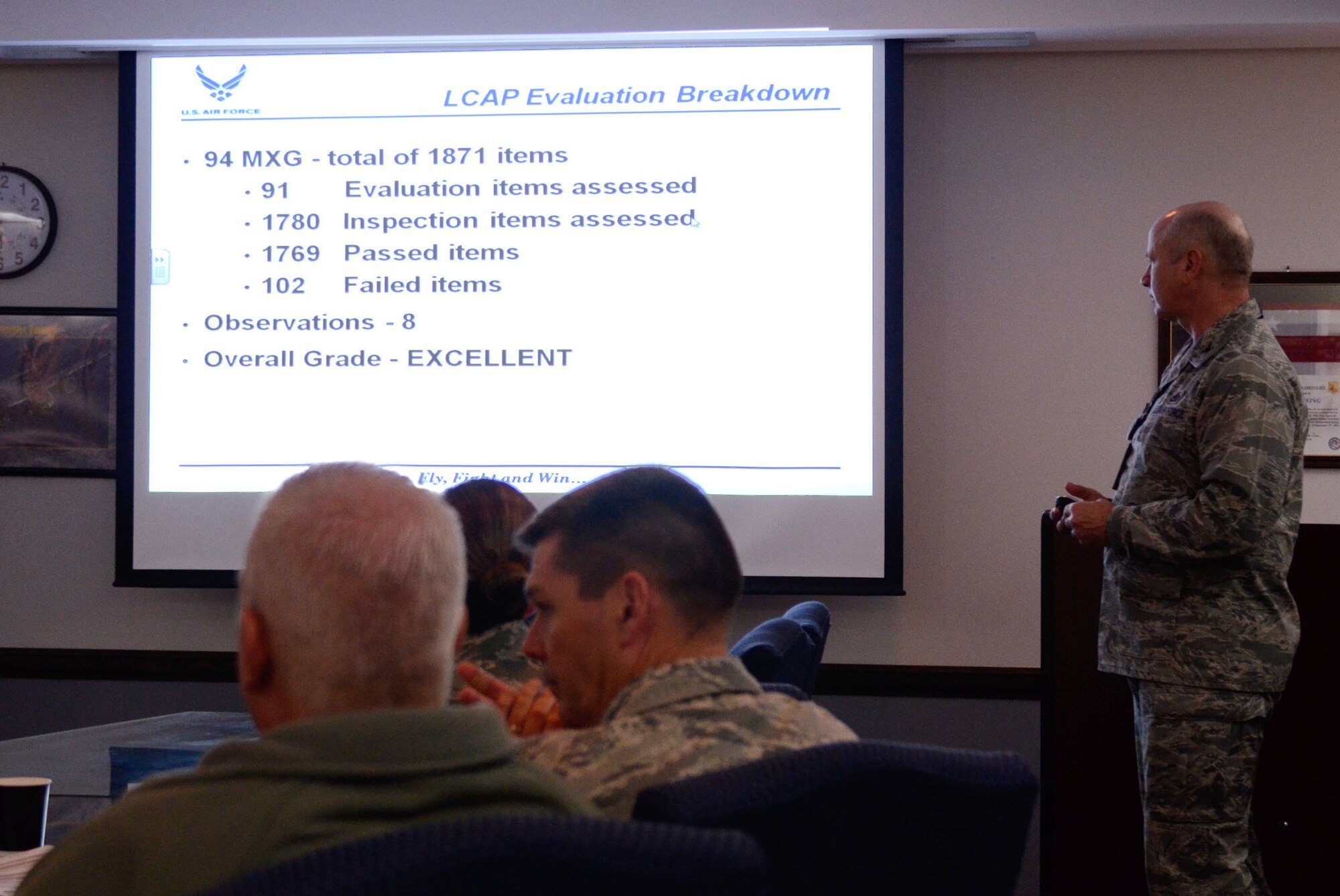 Col. Larry Stephenson, Air Force Reserve Command Logistics Compliance Assessment Program (LCAP) team chief, presents inspection results to Col. Tim Tarchick, 94th Airlift Wing commander and staff during an out-brief Feb. 7. The 94 AW scored an overall satisfactory. (U.S. Air Force photo/Don Peek)