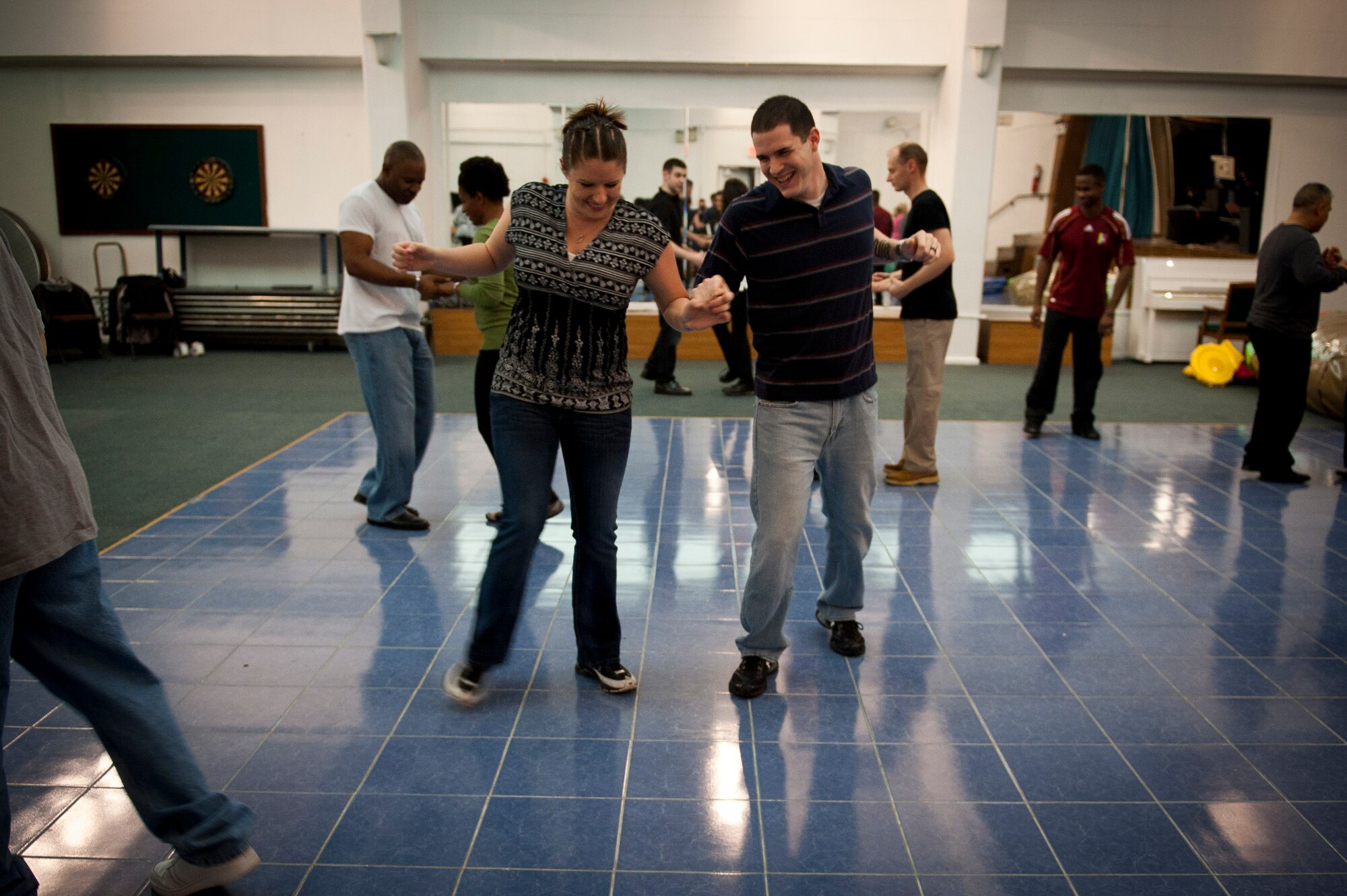 Staff Sgt. Josh Ball, 39th Maintenance Squadron, and his wife, Stacey Ball learn how to dance Feb. 8, 2012, at the community center at Incirlik Air Base, Turkey. The 39th Force Support Squadron offered the Couples Dance Workshop for participants to learn several basic salsa dance steps. (U.S. Air Force photo by Tech. Sgt. Michael B. Keller/Released)