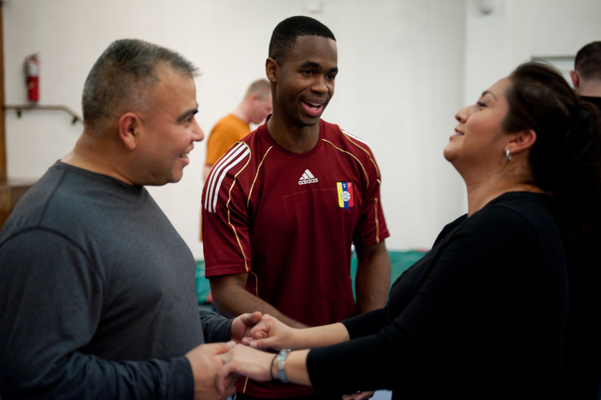 Capt. Lupe Gutierrez, left, 39th Maintenance Squadron, and his wife, Georgia Gutierrez, right, get dancing lessons from Staff Sgt. Freddy Rengifo, 39th Medical Group, Feb. 8, 2012, at the community center at Incirlik Air Base, Turkey. The 39th Force Support Squadron offered the Couples Dance Workshop for participants to learn several basic salsa dance steps. (U.S. Air Force photo by Tech. Sgt. Michael B. Keller/Released)