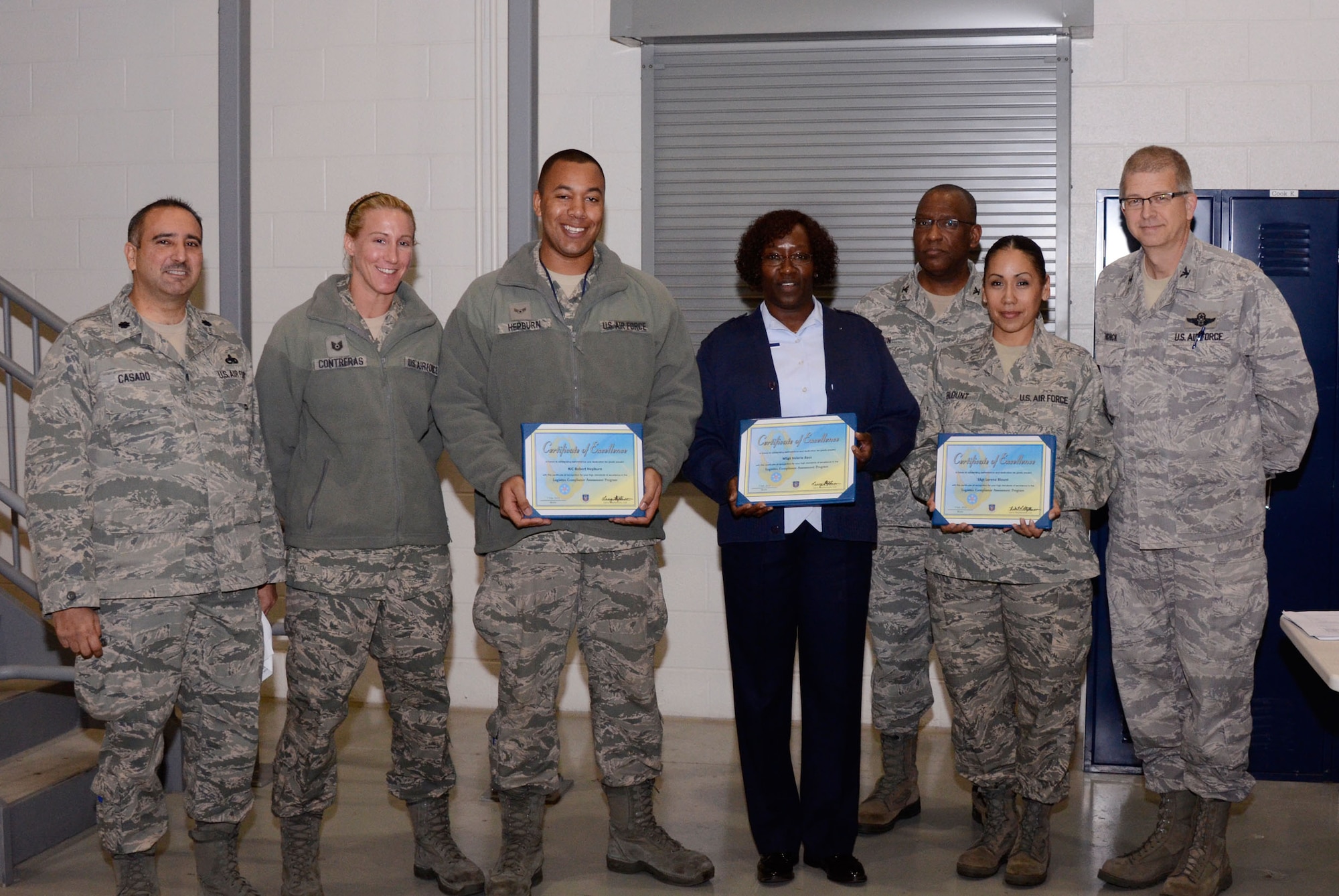Col. Tim Tarchick, 94th Airlift Wing commander, Col. Marshall Irvin, 94th Mission Support Group commander and Lt. Col. Augusto Casado, 94th Maintenance Group commander, present certificates and coins to Air Force Reserve Command Logistics Compliance Assessment Program (LCAP) inspection outstanding performers, Tech. Sgt. Karie A. Contreras and Airman 1st Class Robert Hepburn of the 94th Aircraft Maintenance Squadron, Master Sgt. Valerie Bass of the 94th Maintenance Operation Flight and Staff Sgt. Lorena Blount of the 80th Aerial Port Squadron Feb. 7. (U.S. Air Force photo/Don Peek)