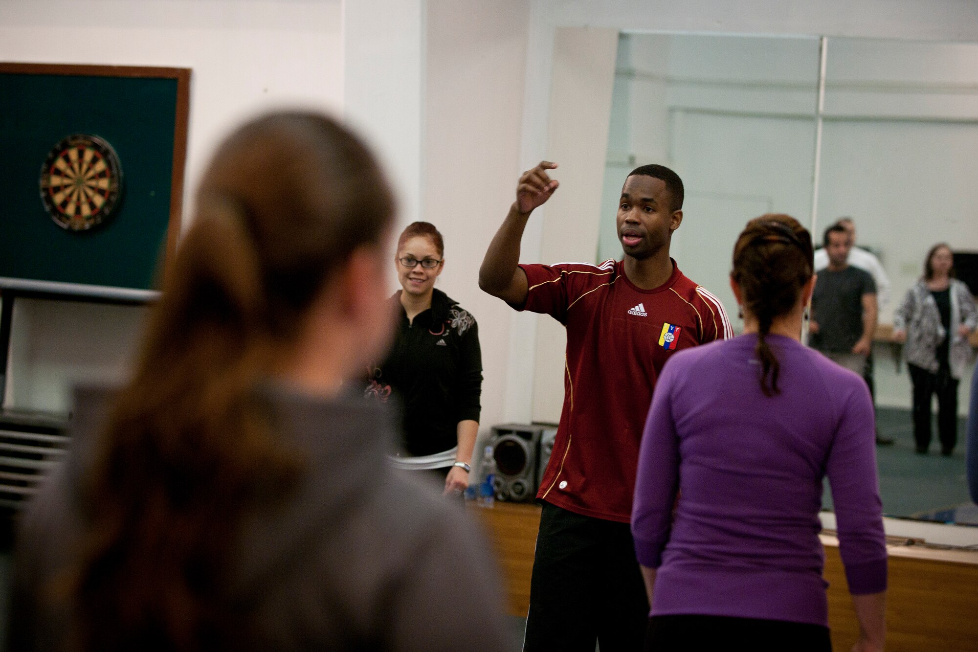 Staff Sgt. Freddy Rengifo, 39th Medical Group, teaches a dance class Feb. 8, 2012, at the community center at Incirlik Air Base, Turkey. The 39th Force Support Squadron offered the Couples Dance Workshop for participants to learn several basic salsa dance steps. (U.S. Air Force photo by Tech. Sgt. Michael B. Keller/Released)