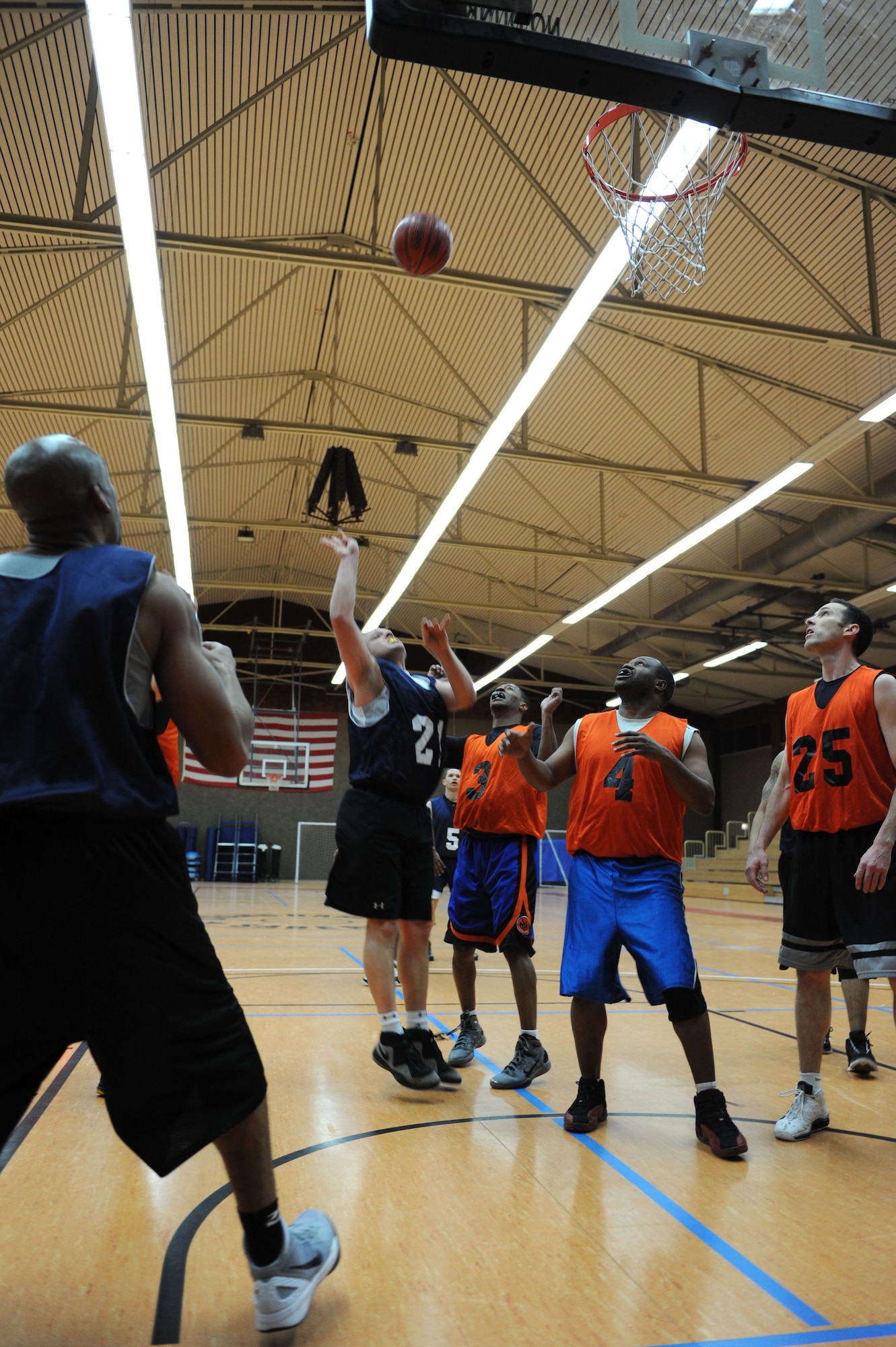 SPANGDAHLEM AIR BASE, Germany – Adam Nichols, 726th Air Mobility Squadron, shoots over 52nd Medical Group defenders during an over-30 basketball league playoff game at the Skelton Memorial Fitness Center here Feb. 7. The 726th AMS team rose to victory against the 52nd MDG with a final score of 37-27. The league championship game will take place Feb. 13 at the fitness center. (U.S. Air Force photo by Senior Airman Christopher Toon/Released)