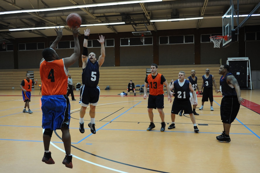 SPANGDAHLEM AIR BASE, Germany - Aloysius Moore, 52nd Medical Group, shoots a three point shot over Mark Dewitz, 726th Air Mobility Squadron, during an over-30 basketball league playoff game at the Skelton Memorial Fitness Center here Feb. 7. The 726th AMS team rose to victory against the 52nd MDG with a final score of 37-27. The league championship game will take place Feb. 13 at the fitness center. (U.S. Air Force photo by Senior Airman Christopher Toon/Released)