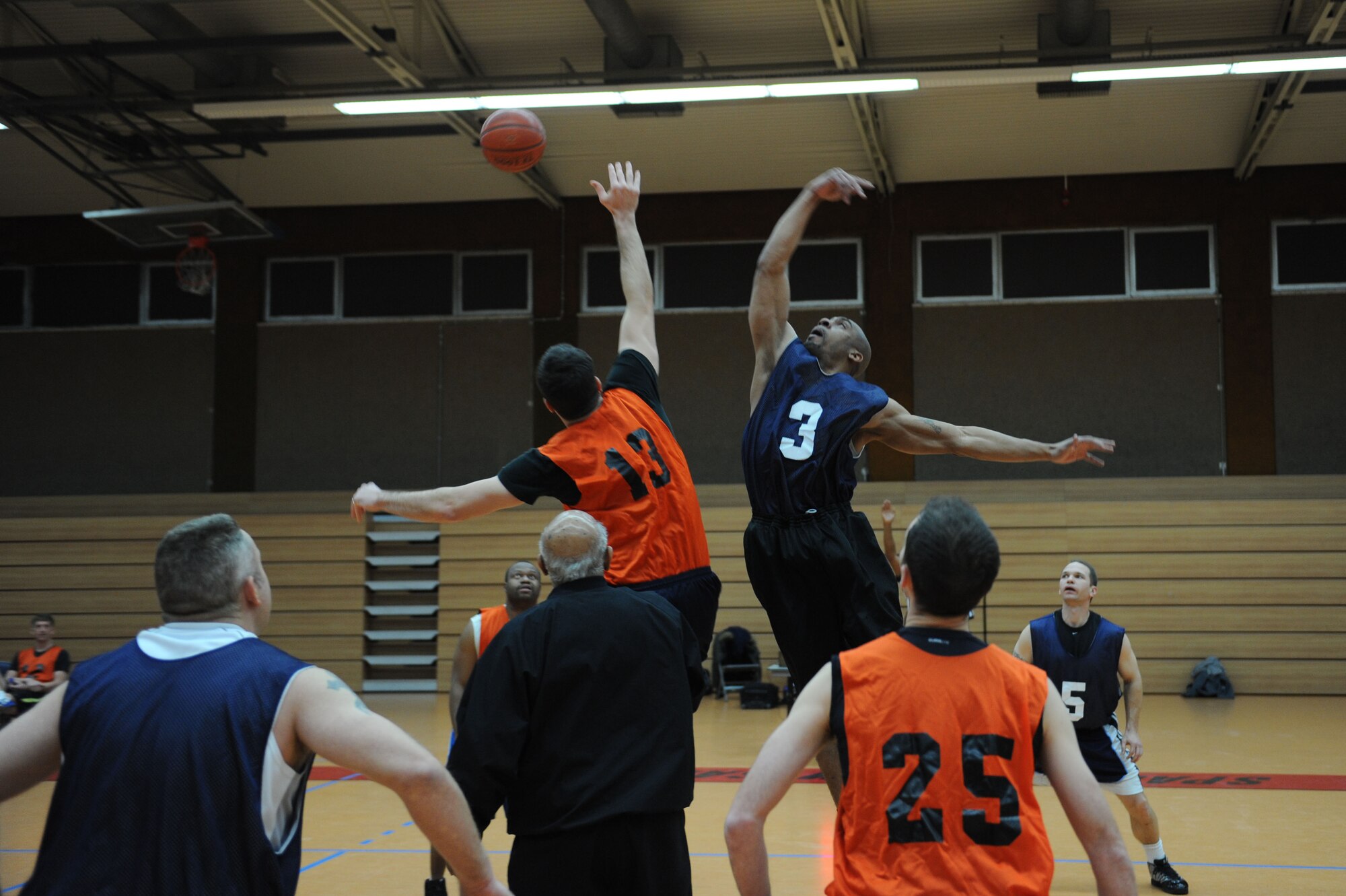 SPANGDAHLEM AIR BASE, Germany –(L to R) Brandon Pieper, 52nd Medical Group, and Tommie Albright, 726th Air Mobility Squadron, jump for the ball during the opening tip-off of an over-30 basketball league playoff game at the Skelton Memorial Fitness Center here Feb. 7. The 726th AMS team rose to victory against the 52nd MDG with a final score of 37-27. The league championship game will take place Feb. 13 at the fitness center. (U.S. Air Force photo by Senior Airman Christopher Toon/Released)