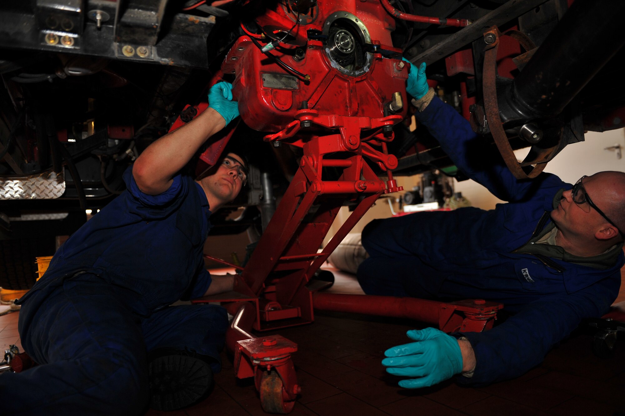 SPANGDAHLEM AIR BASE, Germany – Airman 1st Class Jake Gimigliano, left, and Staff Sgt. Roger Kruback, 52nd Logistics Readiness Squadron vehicle maintenance technicians, align a transfer case block before it can be pieced together and bolted together during a transfer case rebuild on a P26 Tanker Truck inside the fire truck maintenance shop here Feb. 8. The transfer case is essential to the operation of the P26 Tanker Truck because it’s the gear box that transfers power from the transmission to the front and rear wheels enabling the truck to drive in extreme weather conditions.The fire truck maintenance shop consists of 12 technicians and is responsible for the maintenance of more than 50 heavy equipment vehicles such as fire trucks, aircraft deicers and aircraft load equipment. Technicians assigned to the fire truck maintenance shop ensure daily operations continue even when fire or ice present potential hindrances. (U.S. Air Force photo by Airman 1st Class Dillon Davis/Released)