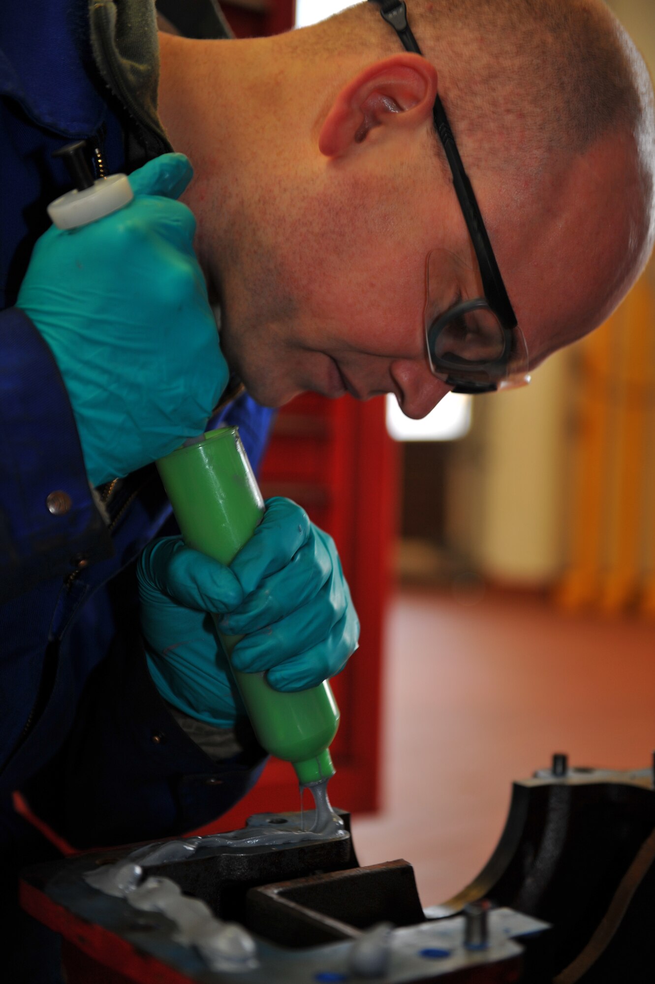 SPANGDAHLEM AIR BASE, Germany – Staff Sgt. Roger Kruback, 52nd Logistics Readiness Squadron vehicle maintenance technician, applies high-temperature gasket sealant before the transfer case block can be mounted during a transfer case rebuild on a P26 Tanker Truck inside the fire truck maintenance shop here Feb. 8. The high-temperature gasket sealant is needed to prevent leaks from between contact points that could lead to damage of the vital internal components. The transfer case is essential to the operation of the P26 Tanker Truck because it’s the gear box that transfers power from the transmission to the front and rear wheels enabling the truck to drive in extreme weather conditions.The fire truck maintenance shop consists of 12 technicians and is responsible for the maintenance of more than 50 heavy equipment vehicles such as fire trucks, aircraft deicers and aircraft load equipment. Technicians assigned to the fire truck maintenance shop ensure daily operations continue even when fire or ice present potential hindrances. (U.S. Air Force photo by Airman 1st Class Dillon Davis/Released)